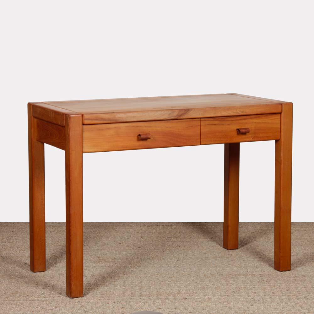Solid elm desk produced in France by Maison Regain in the 1970s. It has two drawers with leather handles. This piece of vintage furniture is in good original condition.