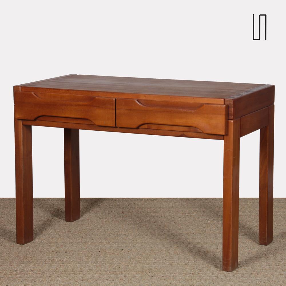 This solid elm desk was produced in France by Maison Regain around 1980. It includes two drawers. This piece of vintage furniture is in good original condition. 