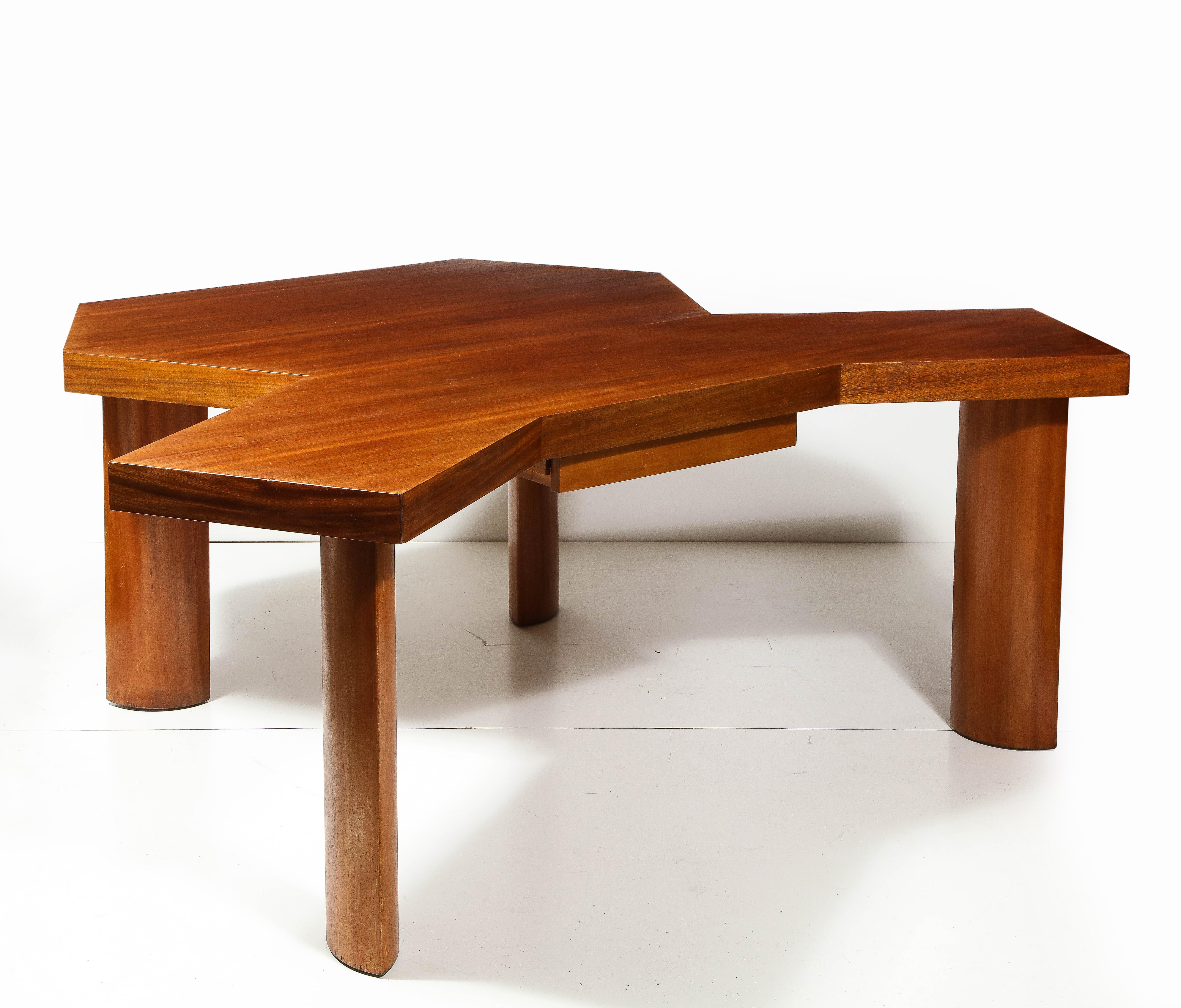 Unique, impressive desk in the manner of Charlotte Perriand. The beautifully aged, warm-toned elm lends itself beautifully to the organic yet defined shapes of the double desk top and sculpted legs. 


