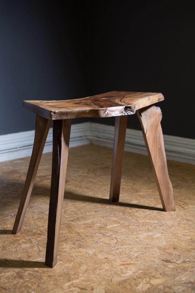 This beautiful handcrafted table shows a cross-section of the limb of an elm tree that had been struck by lightning.
The scar shows how the tree had tried to heal the wound and is a great visual display of nature at work.
The void caused by the