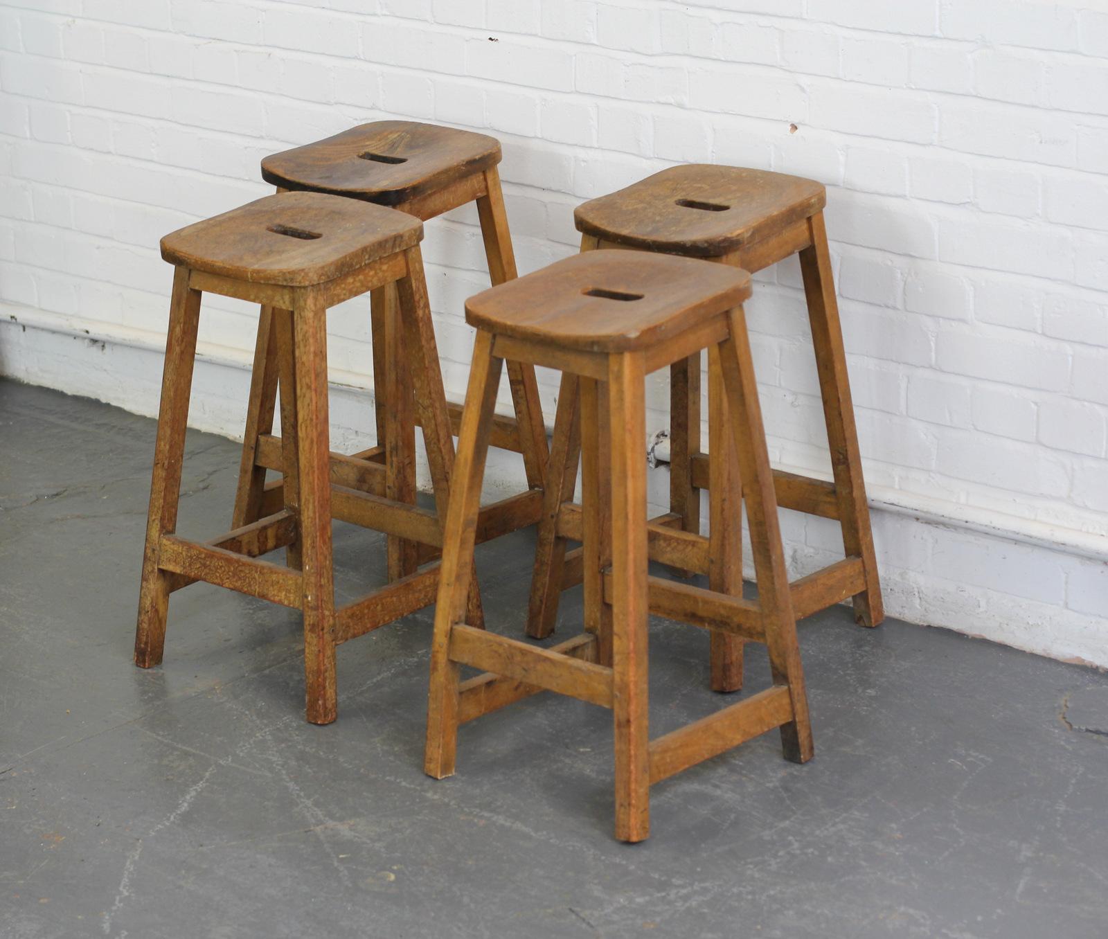 Elm Machinists stools, circa 1950s

- Price is per stool (4 available)
- Solid elm frames
- Solid elm seats with cut-out handle 
- The seats have a tilt design 
- Stamped by the Maker
- Salvaged from the engineering dept of Birmingham