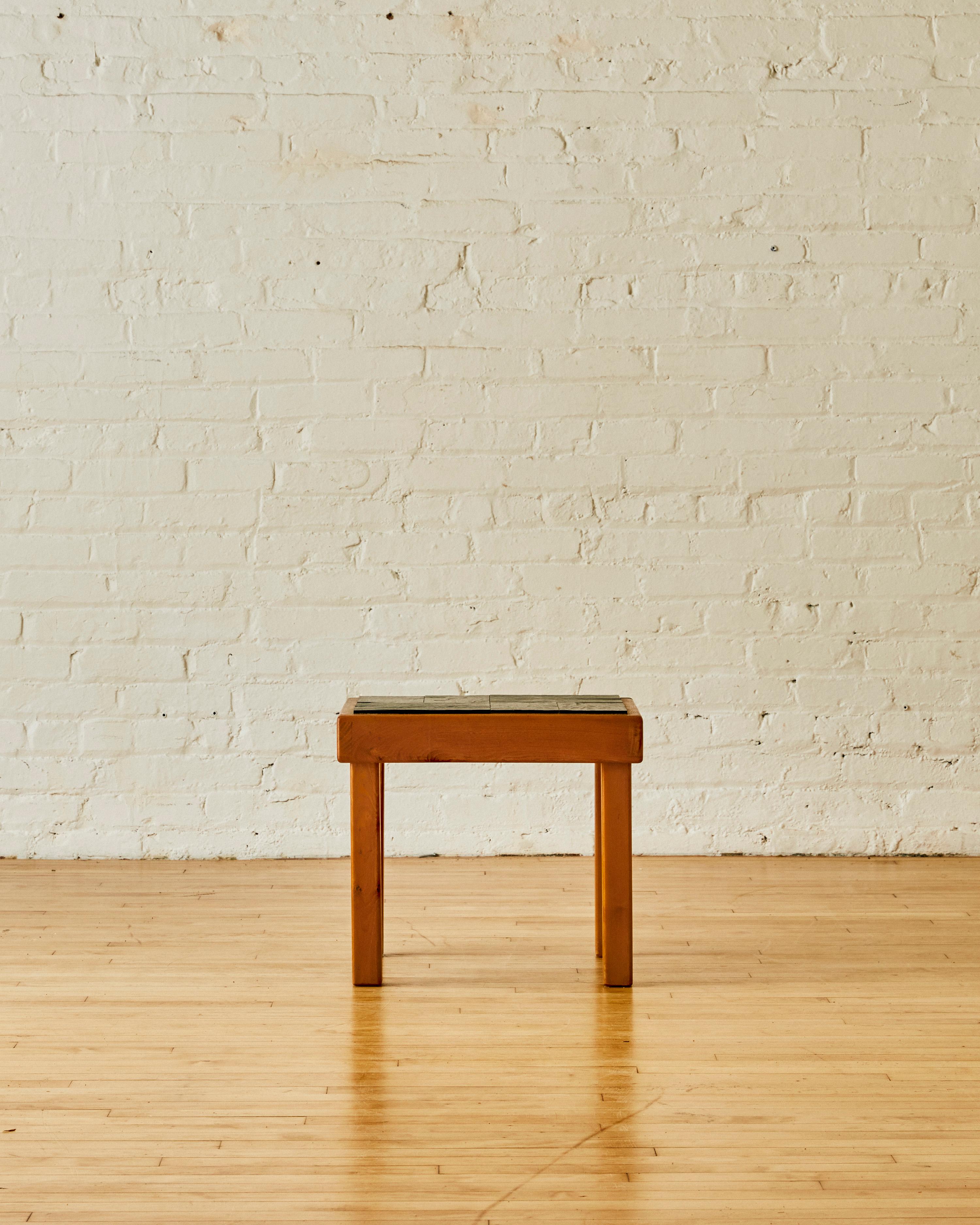 Elm side table by Pierre Chapo for Maison Regain with a slate table top C.1960

Pierre Chapo (1927-1987) was a French furniture designer and craftsman who was active in the mid-20th century. He is known for his minimalist and functional designs,
