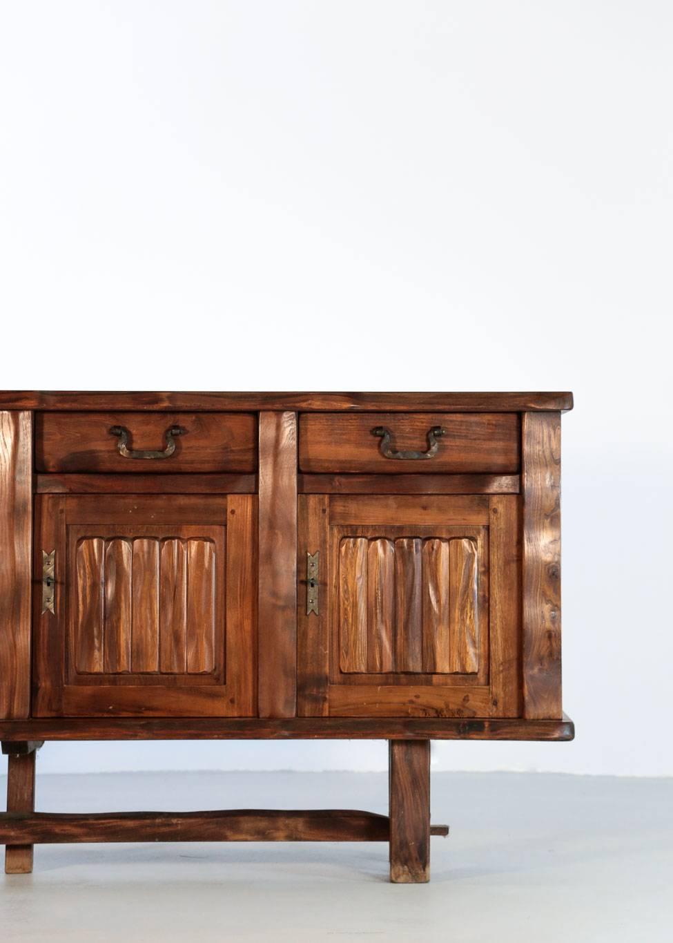 Solid elm sideboard designed by Olavi Hanninen. 
Composed of four doors and three drawers. Handles in black metal.
Excellent condition.