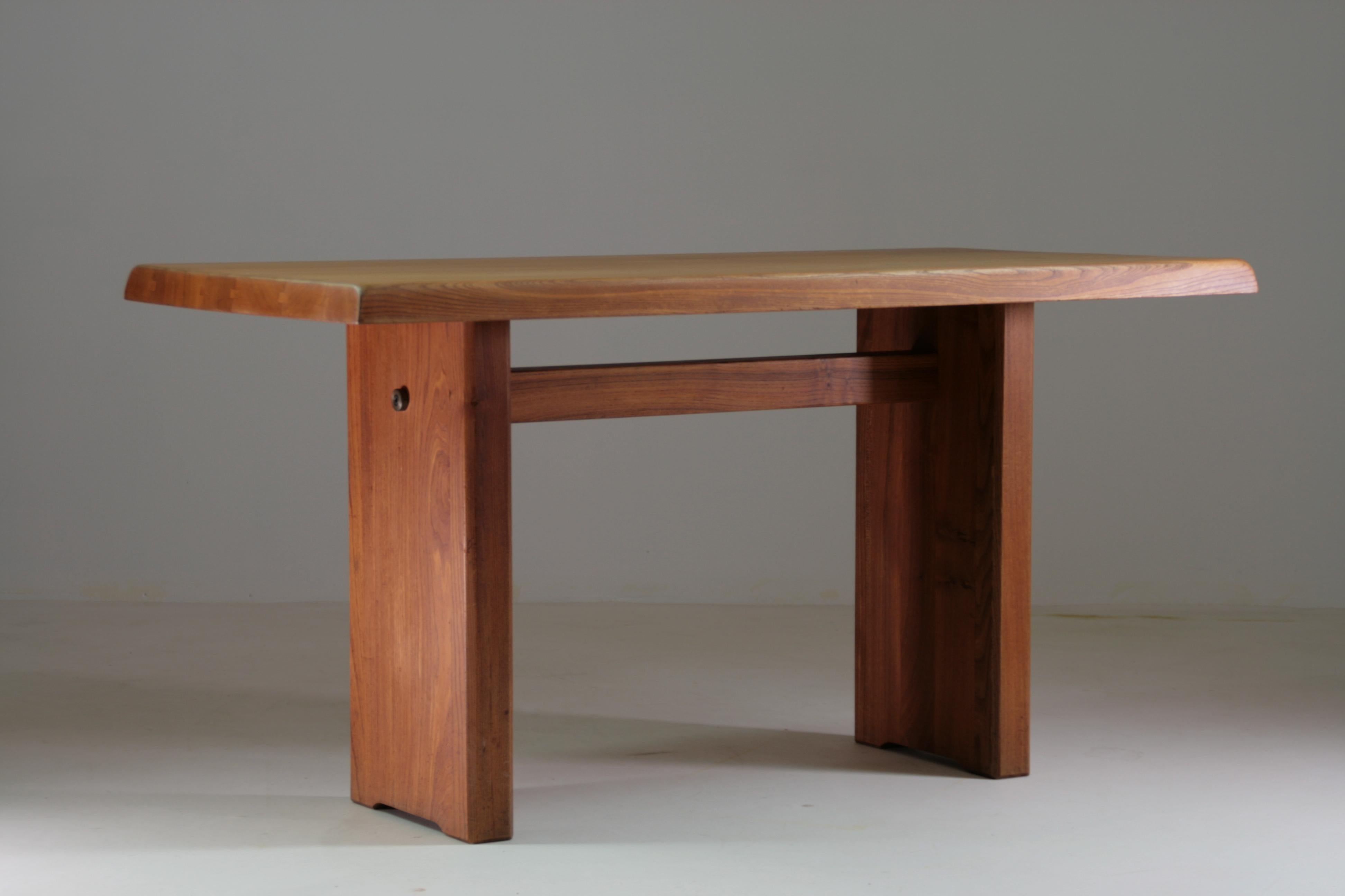 Raw elegance and timeless craftsmanship meet in this rectangular table in solid natural elm, model T14A, designed by Pierre Chapo. A true icon of 1970s French design, the T14A embodies the designer's radical and poetic vision, combining
