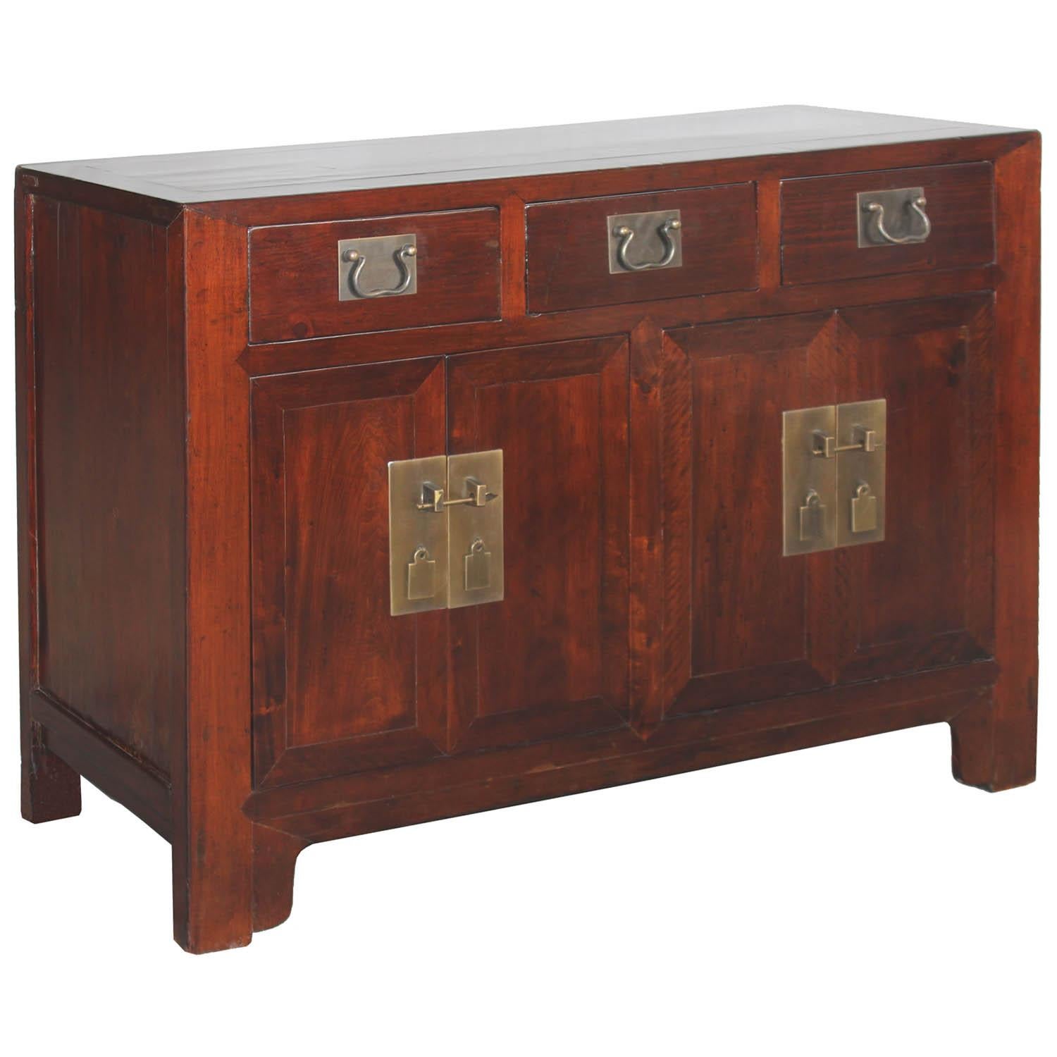 Elm buffet with three drawers and brass hardware. New interior shelf and hardware. Use as a server in the dining room or in the living room beneath artwork or a flat screen tv. Tianjin, China, circa 1940s.