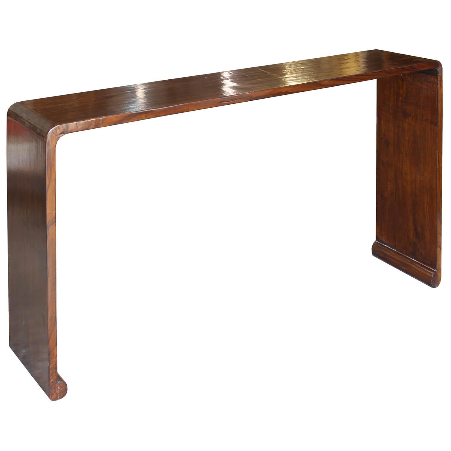 Contemporary elm console table with beautiful wood grain and waterfall sides makes an elegant statement in an entry or living room.
