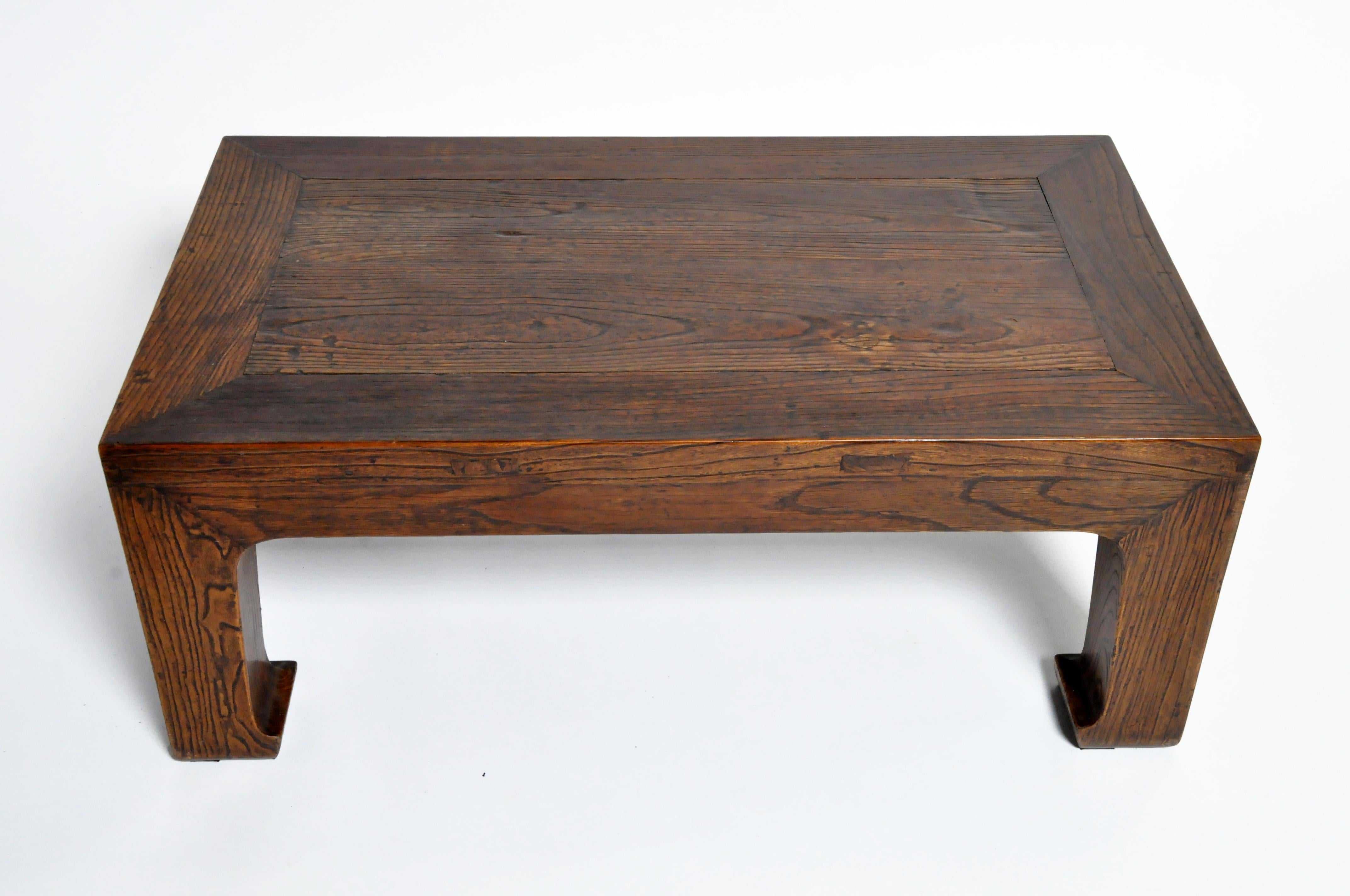 Elm wood coffee table this sturdy coffee table is actually a cut-down Chinese daybed. Elmwood was the preferred furniture wood in Northern China during the 19th century. The large legs (in the Tang horse-hoof style) once supported a much larger top.