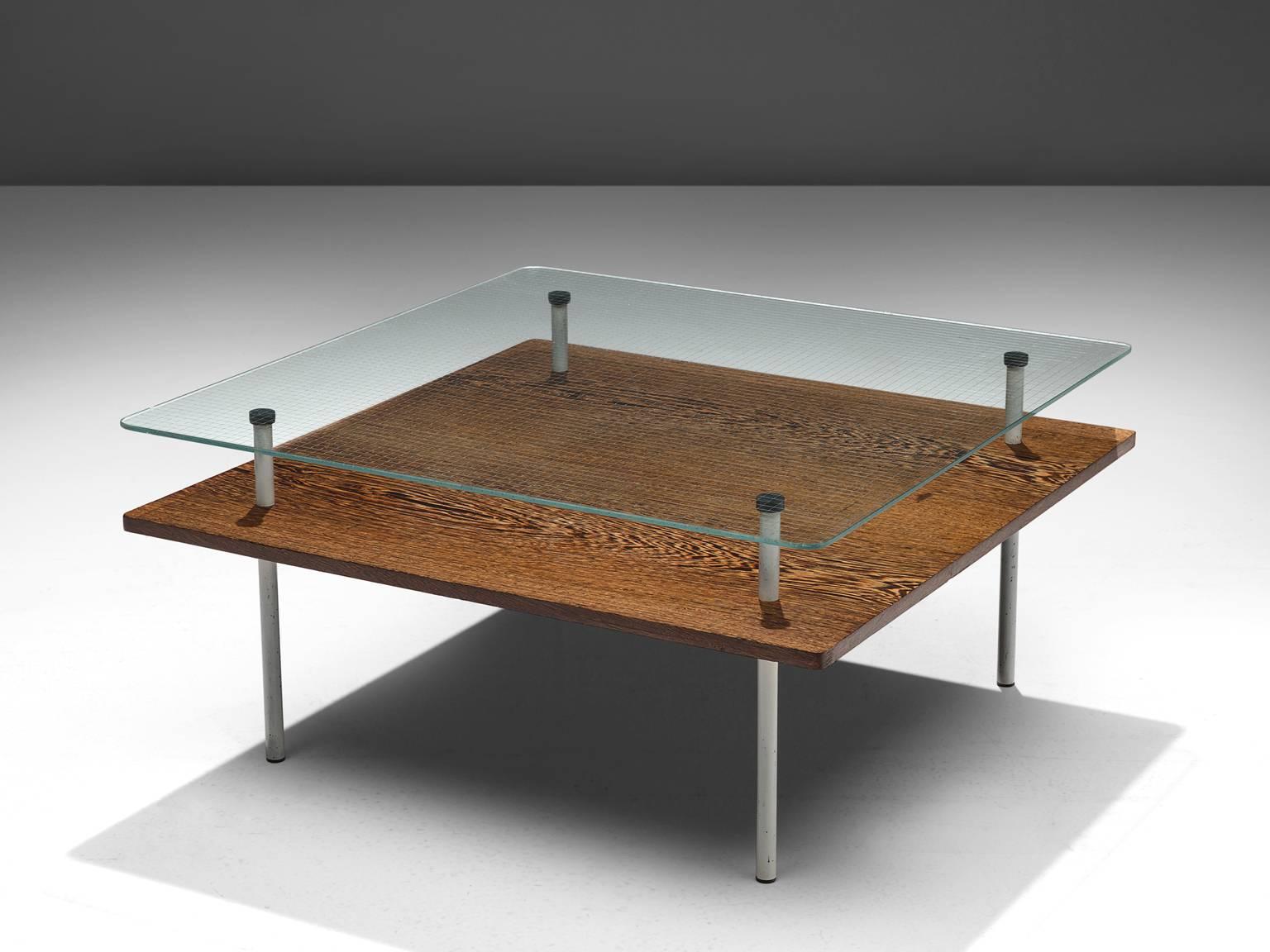 Elmar Berkovich for Metz & Co., coffee table, wengé, white coated metal and reinforced glass, the Netherlands, circa 1935.

This modern cocktail table by designer Elmar Berkovich is made by the Dutch company Metz & Co. An interesting combination
