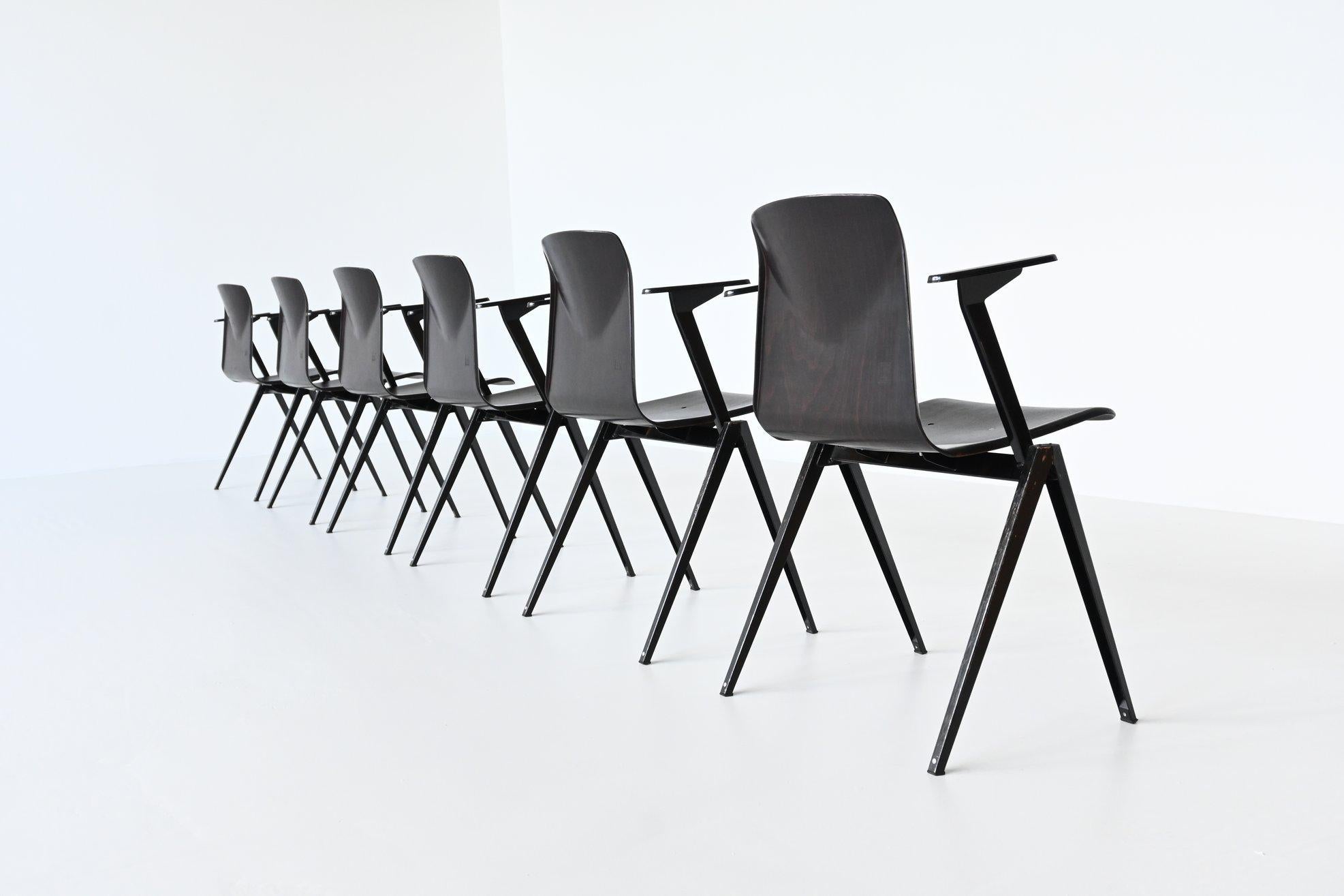 Large lot of 30 stacking chairs with armrests model S22 designed by Elmar Flototto and manufactured by Pagholz, Germany 1970. These chairs have black v-shaped metal frames and dark brown pressed wood seats. They have a nice patina from several years
