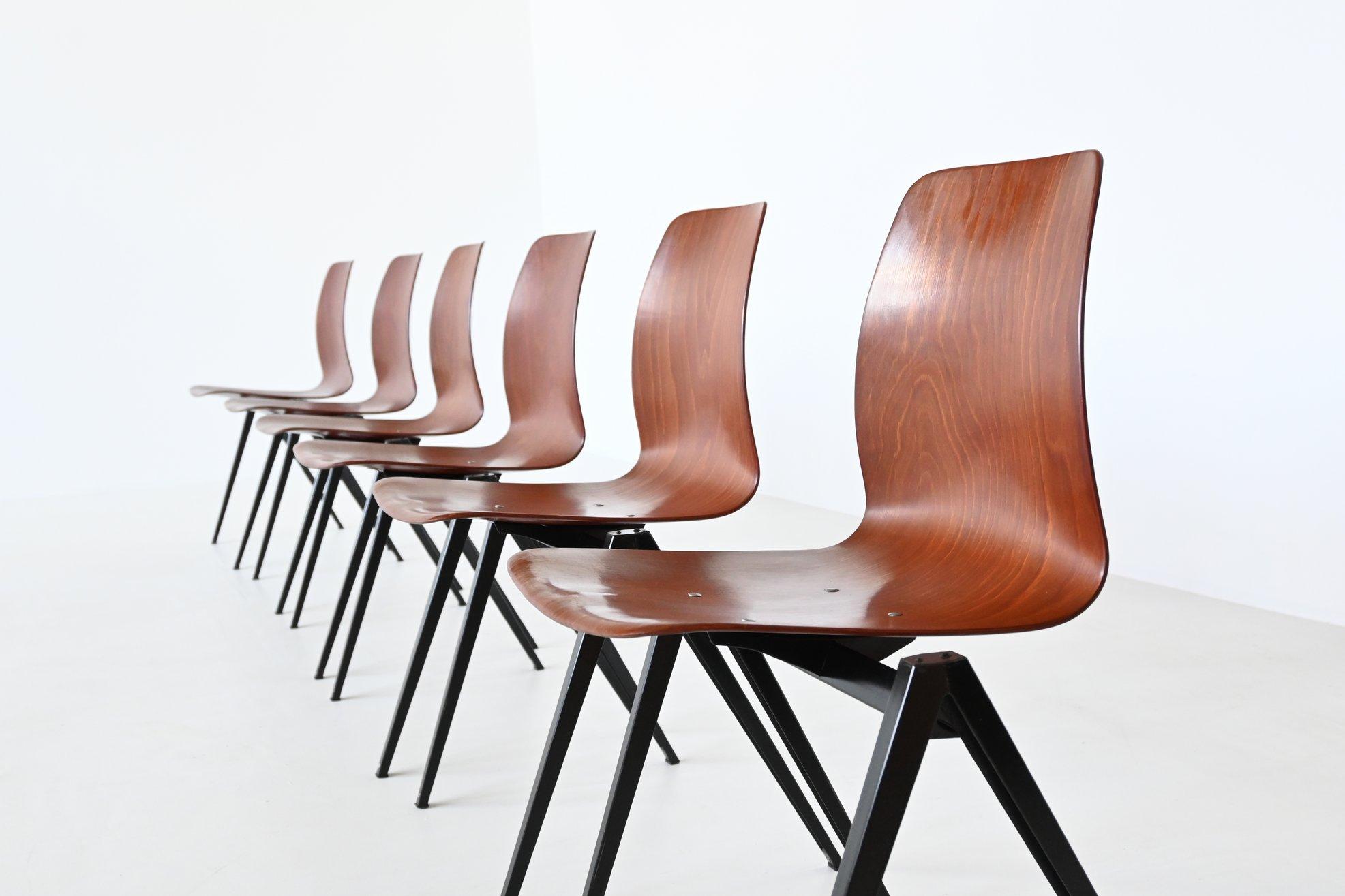 Large lot of 50 stacking chairs model S22 designed by Elmar Flototto and manufactured by Pagholz, Germany 1970. These chairs have black v-shaped metal frames and medium brown pressed wood seats. They have a nice patina from several years of usage,