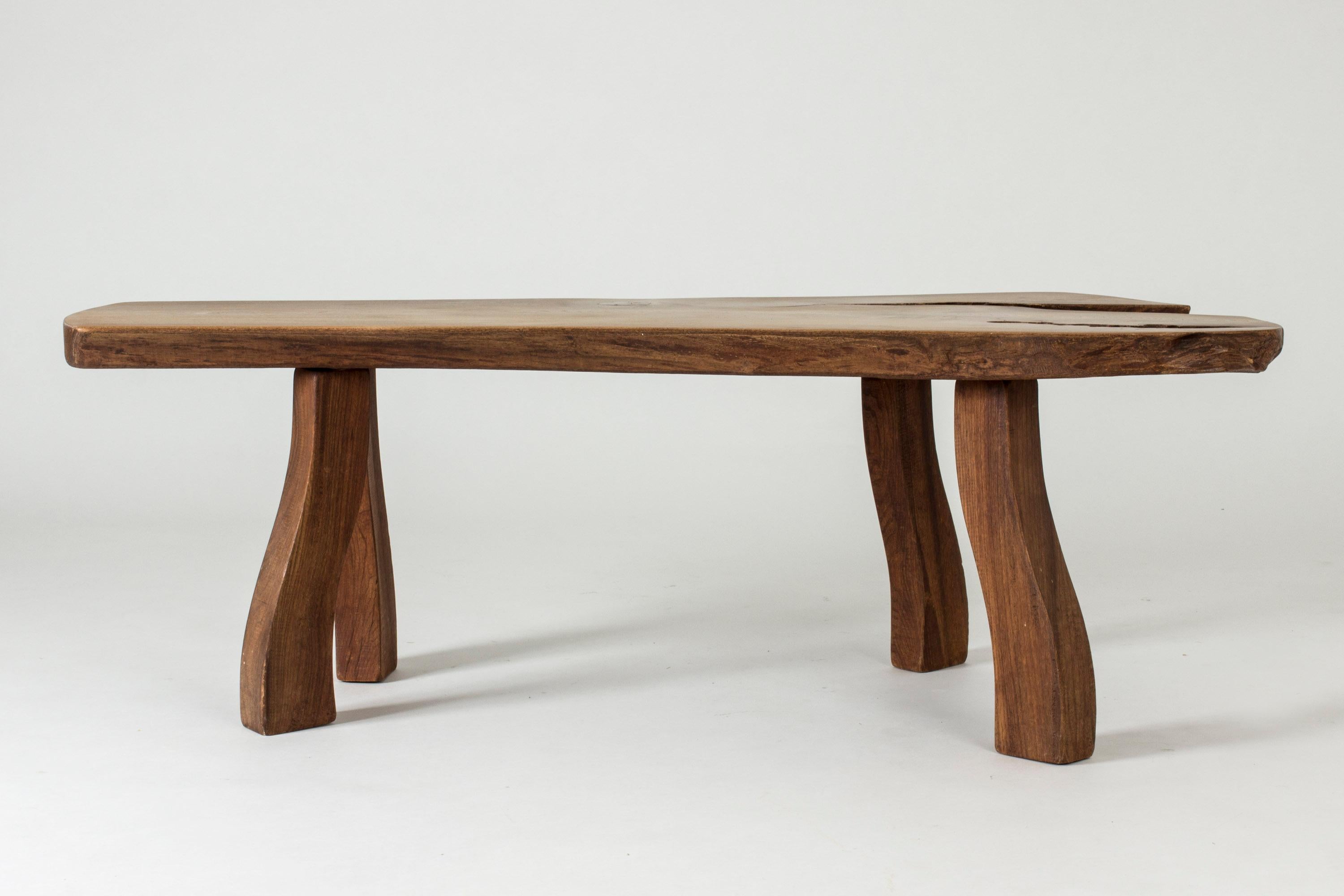 Striking elmwood coffee table by Carl-Axel Beijbom, made from an elmwood slab with interesting knots and wood grain. Beautiful, oiled surface. Sturdy, sculpted legs that pick up the organic design of the tabletop. Can alternatively be used as a side