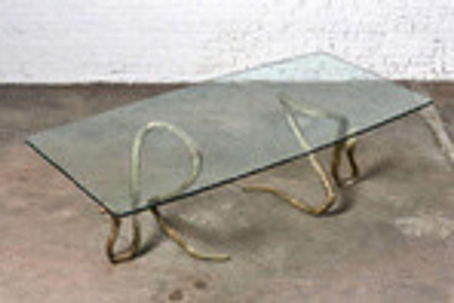 ELODIA Sculptural Brass Cobra and Glass Dining Table. Beautiful patina to brass serpent snake bases. Glass top has a multifaceted/polished chip edge, which increases its ability to reflect light. The play on light is gem like. Signed “ELODIA”.