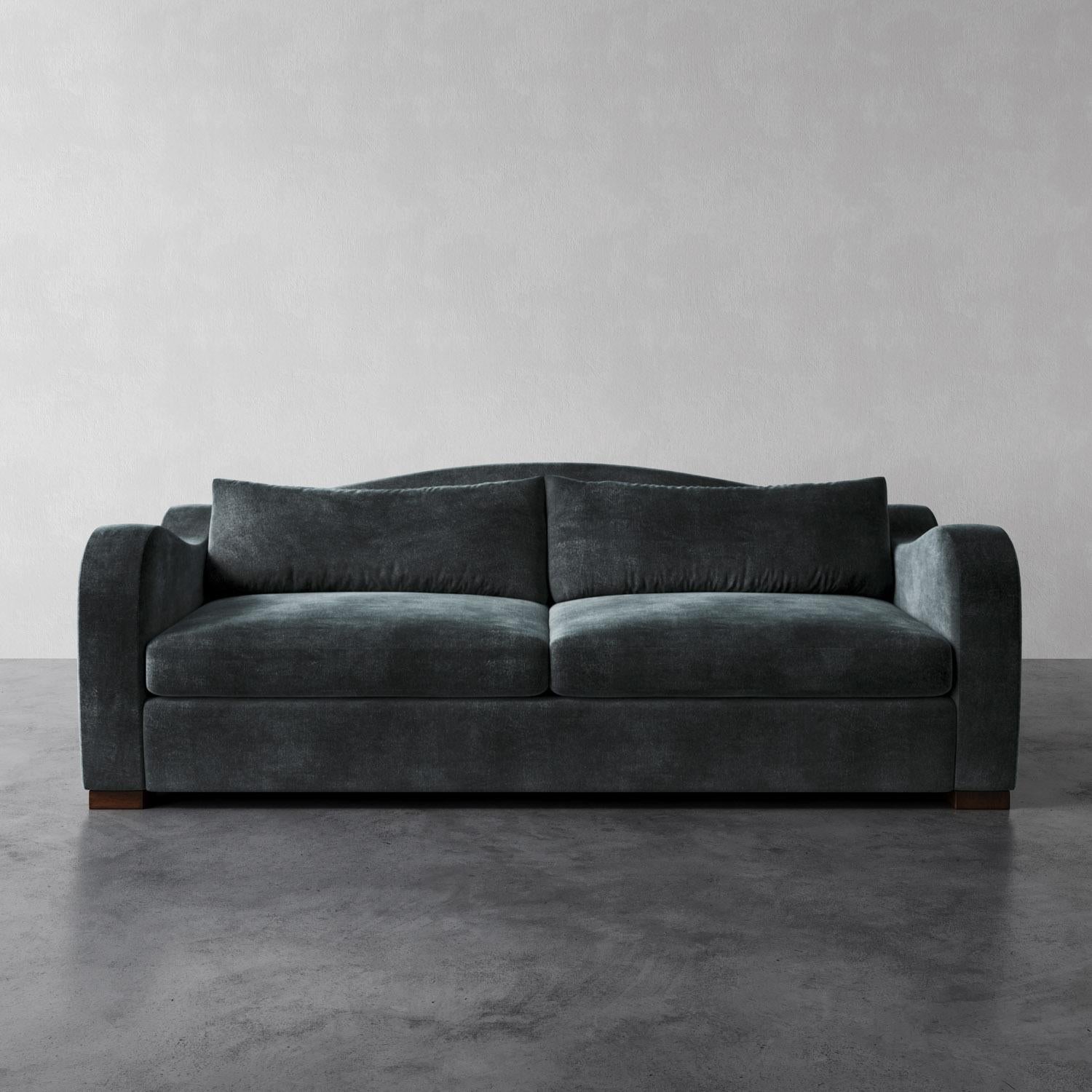 The Elodie Sofa draws inspiration from the elegant curves of 1930s French design, channeling the works of Jean Royère, Pierre Chareau and Marc du Plantier. With its deep seat, soft back cushion, and swooping arms, it balances luxury and modernity,