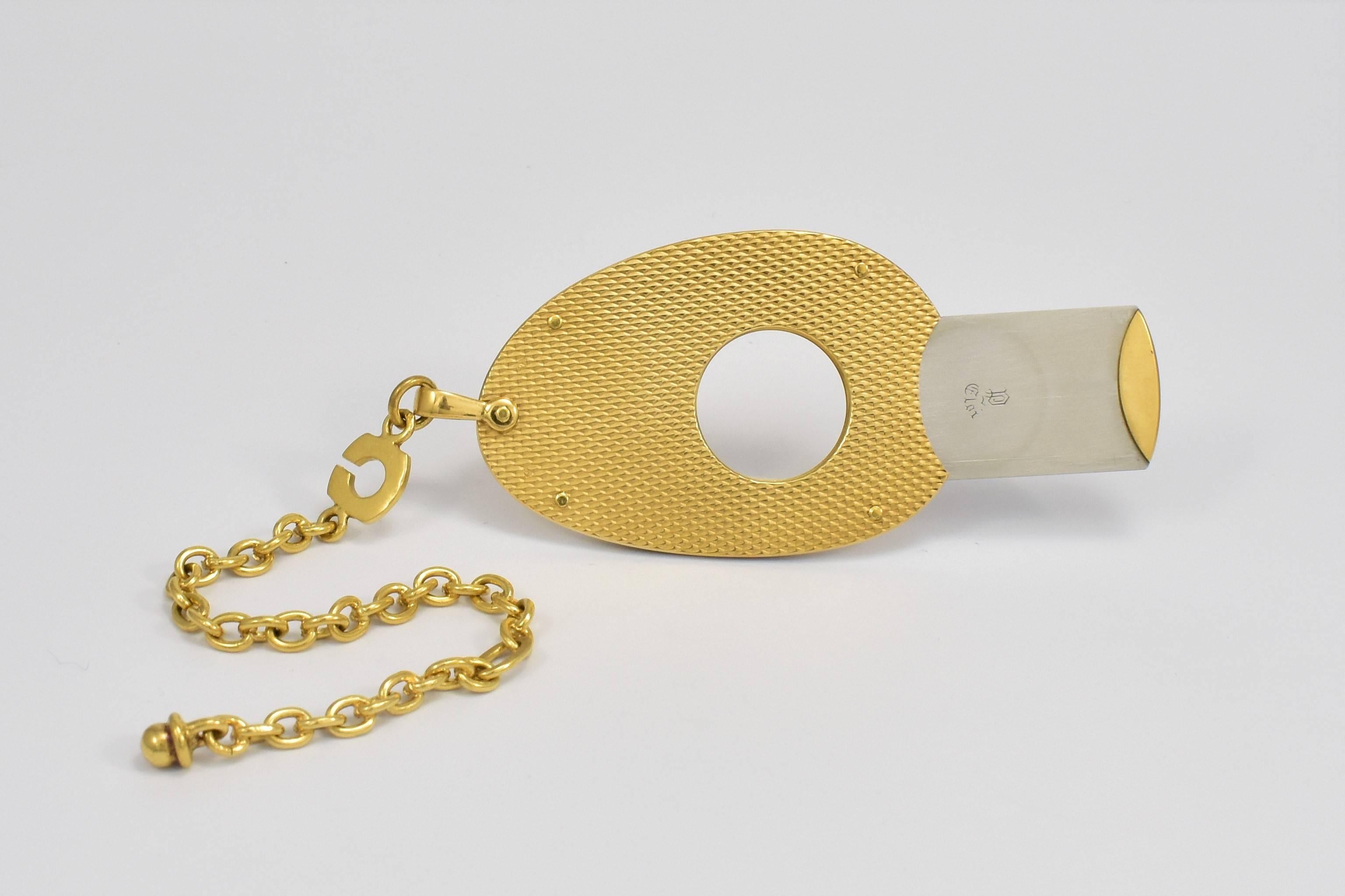An Eloi oval shaped cigar cutter with a highly polished textured finish. No UK Hallmark as originated in France, however tested as 18 karat gold with a stainless steel inside for blade etc. French hallmark. Unused and sharp full function as new.
