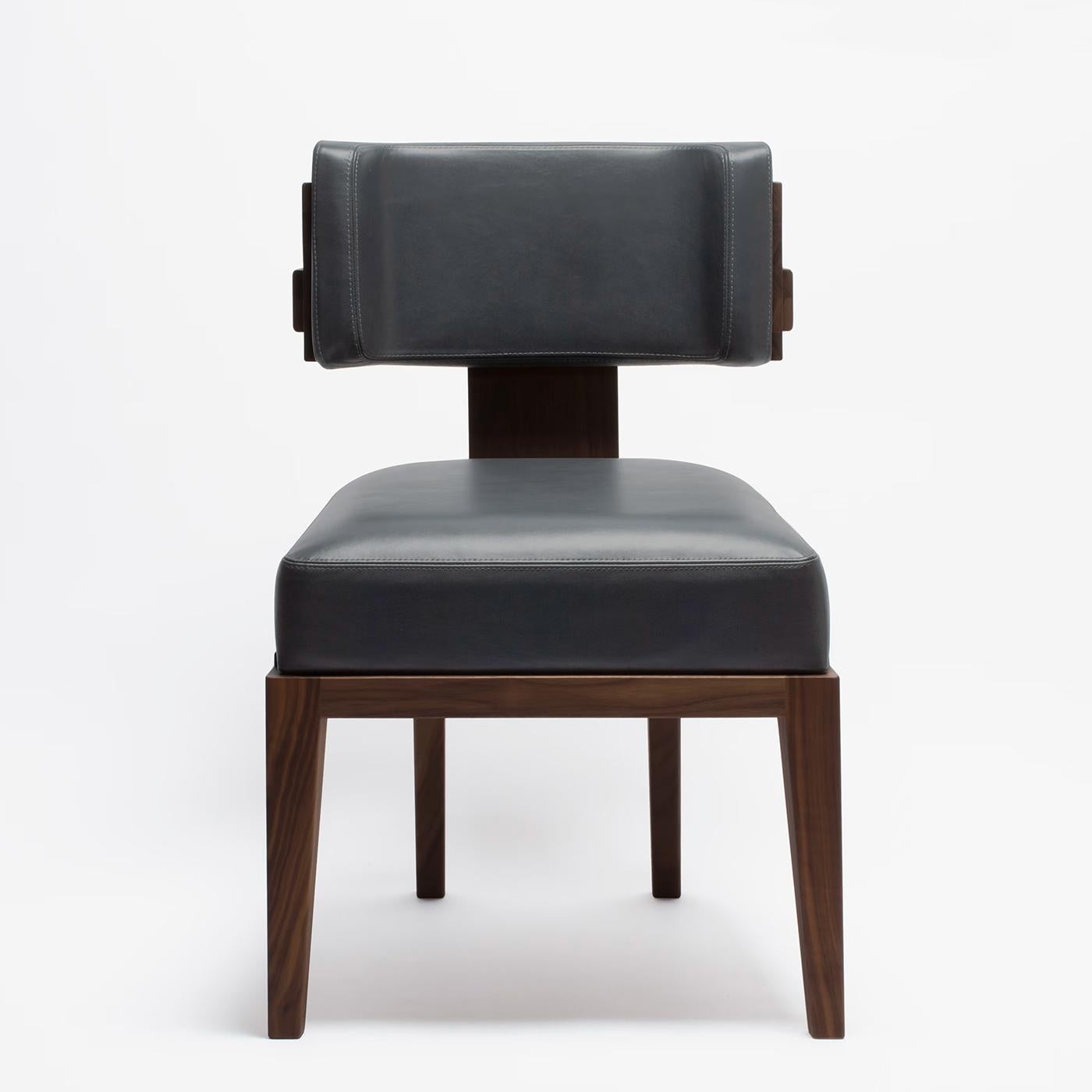Chair Eloise walnut with solid walnut wood structure.
Upholstered and covered with high quality genuine. 
Black leather.