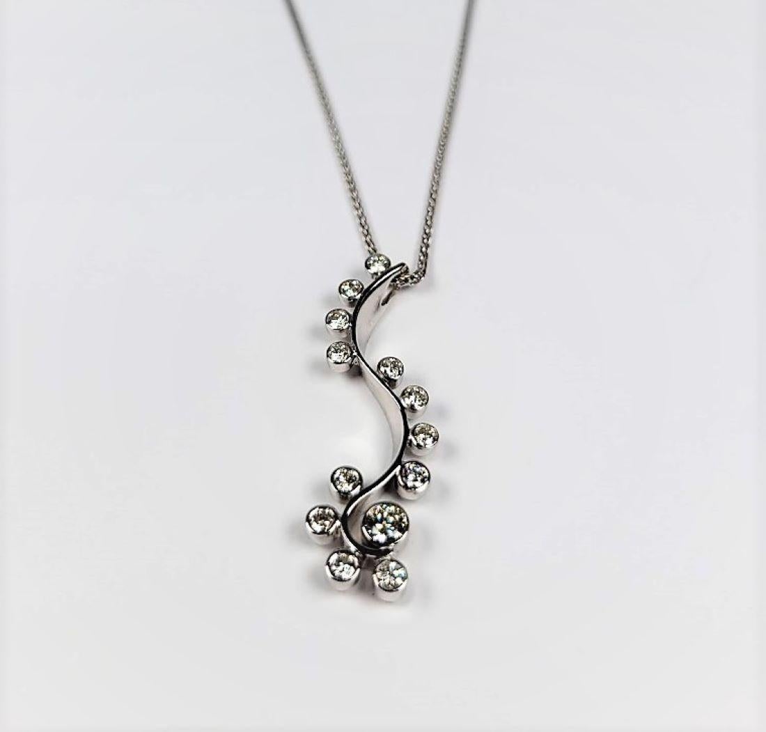 Round Cut Elongated and Swirling 0.65 Carat Diamond Necklace For Sale