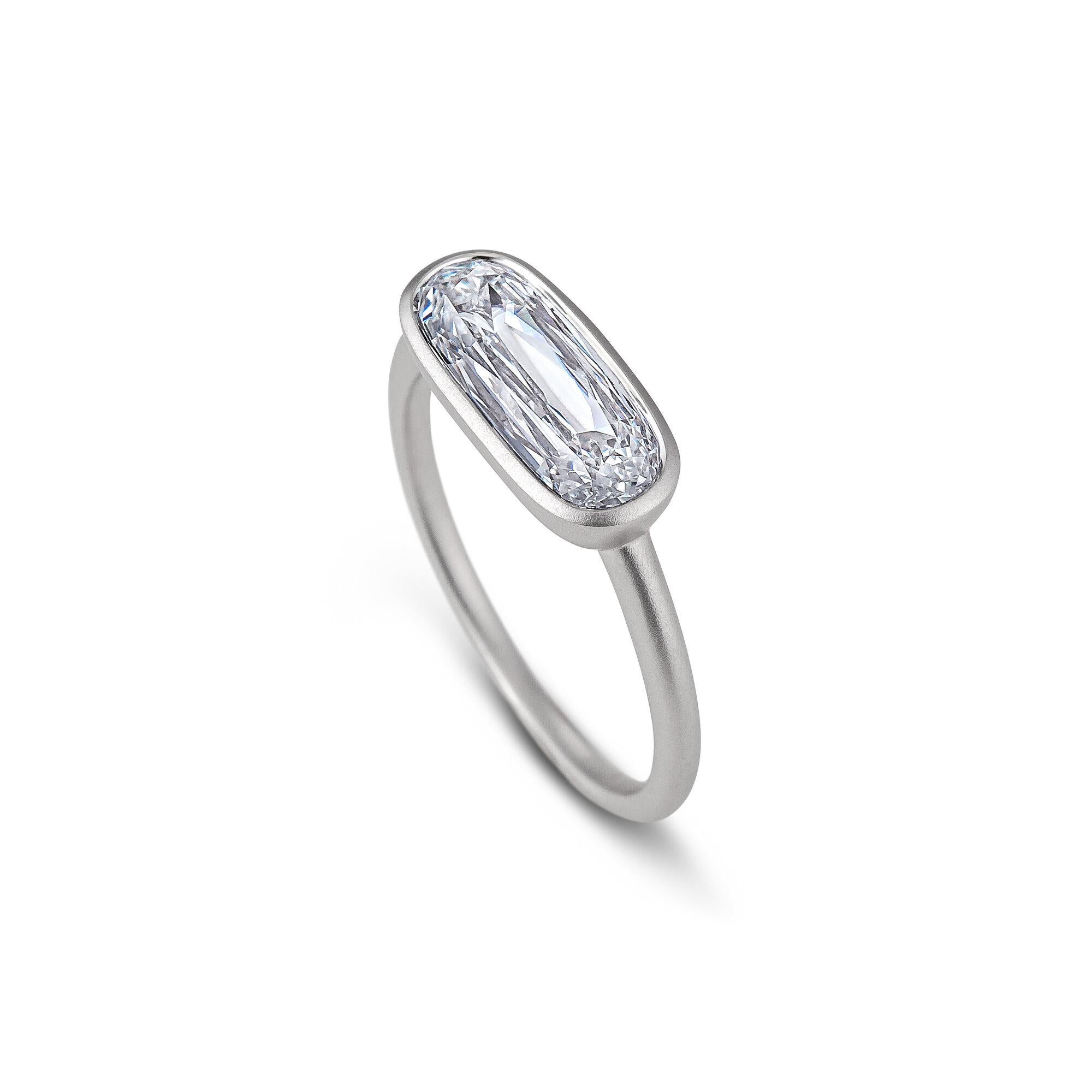 Pointing East to West, this elongated cushion cut 1.75 carat GIA certified diamond engagement ring, designed in a sleek modern bezel setting, is a one-of-a-kind standout from coast to coast.  Diamond color H.  Clarity VS2.  GIA certification