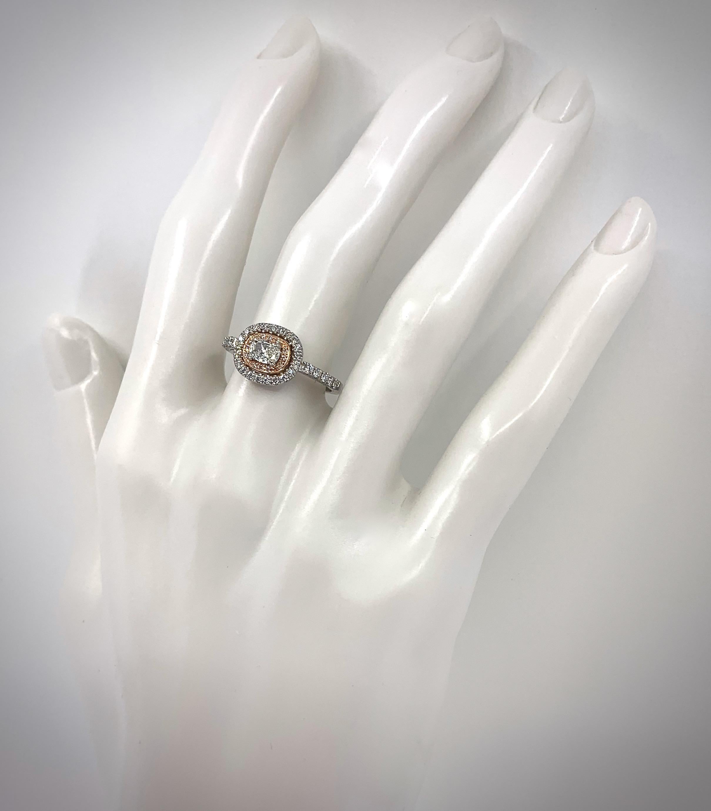 The stone shape, the rose gold contrast and the horizontal orientation are great design elements in this lovely little halo ring by Eytan Brandes.

In subtle elevations, a cushion-cut rectangle diamond is prong-set within concentric halos of rose