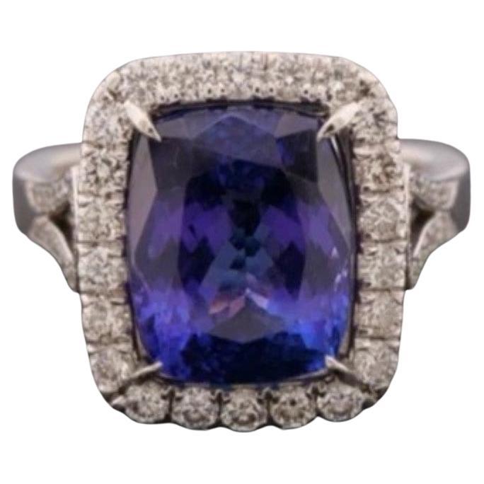 Offered is one (1) lady’s tanzanite and diamond halo ring crafted in white gold, tested as 14K (see photos for metal testing). The ring features an elongated cushion-cut natural tanzanite, measuring approximately 12.00 x 9.65 x 7.45 mm, with an
