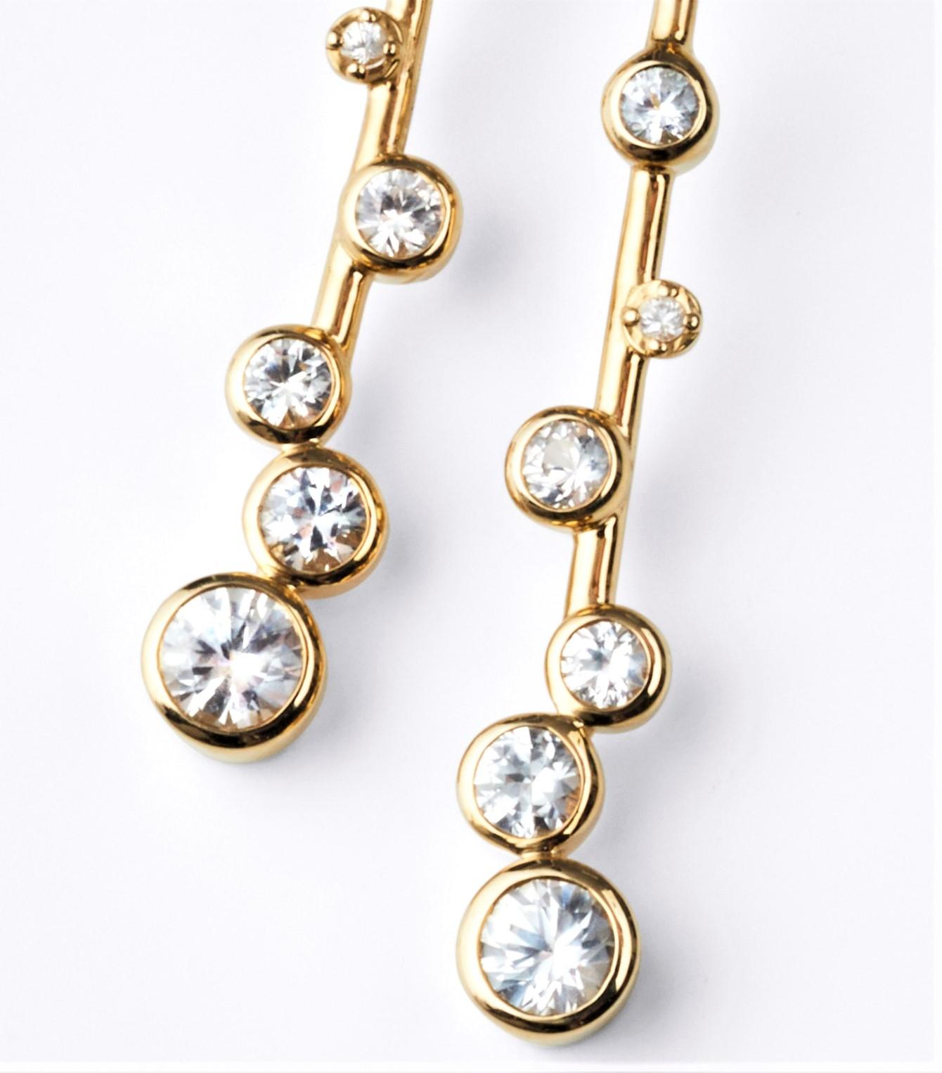 Hip, sophisticated, fun celebration of the stars.... don't keep these earrings in your lock box - these are meant to be worn!!!   
These Elongated Constellation earrings are 14k  with 1.1 carats of sparkling white sapphires; and 0.08 carats of