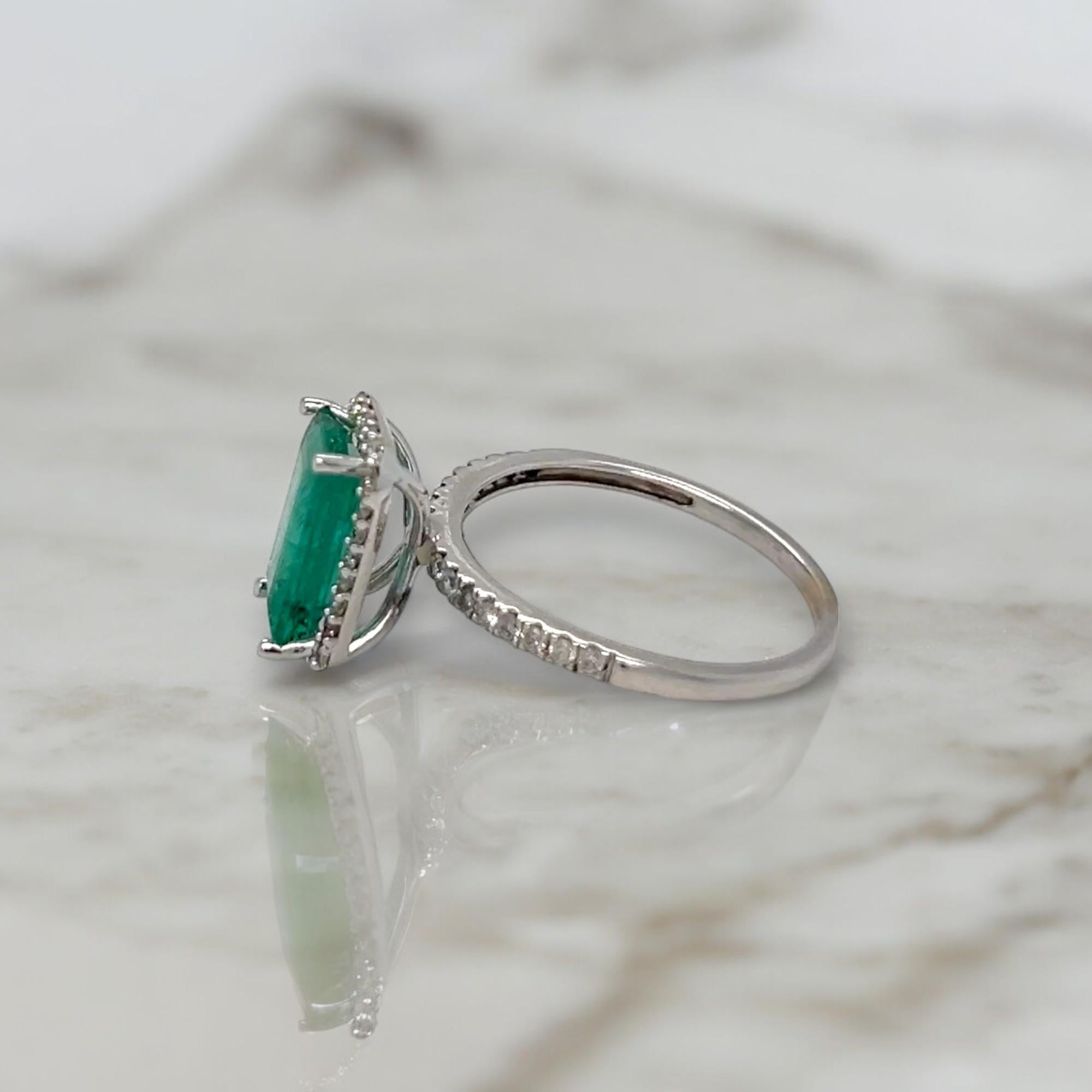 Emerald Cut Elongated Emerald and Diamond Halo White Gold Statement Ring For Sale