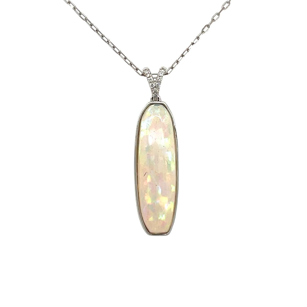 This vibrant elongated Ethiopian Opal and diamond pendant is bezel set in 14 karat white gold. There are sparkling brilliant cut diamonds on the bail for a beautiful accent. This pendant will be shipped in a beautiful box, ready for the perfect