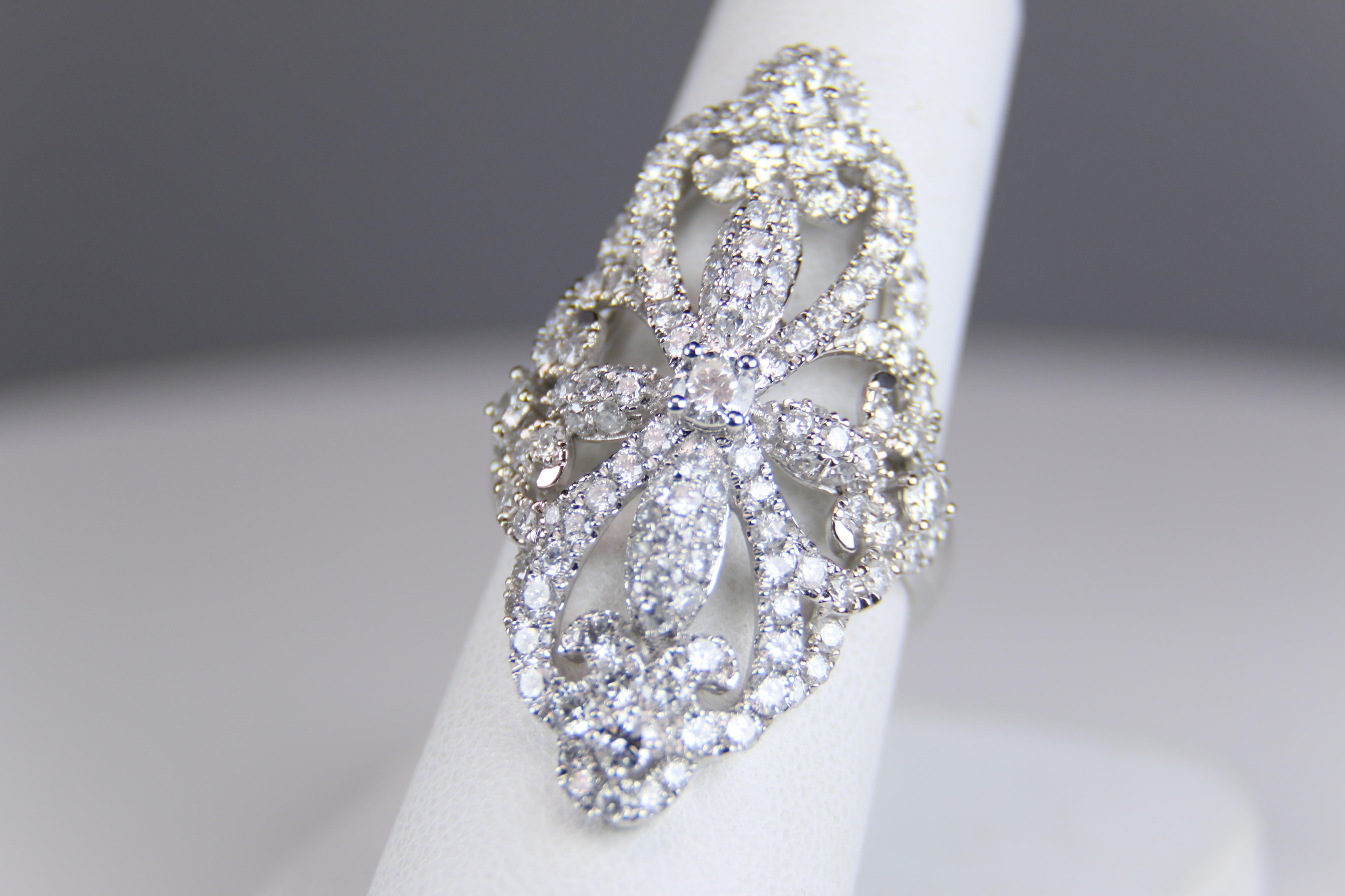 Elongated Filigree Diamond and 14K White Gold Ring features an estimated 1.90 carats of white, eye clean round brilliant cut diamonds both pave and prong set in an open filigree style design. Ring is an impressive 1.5 inches long so as to accentuate