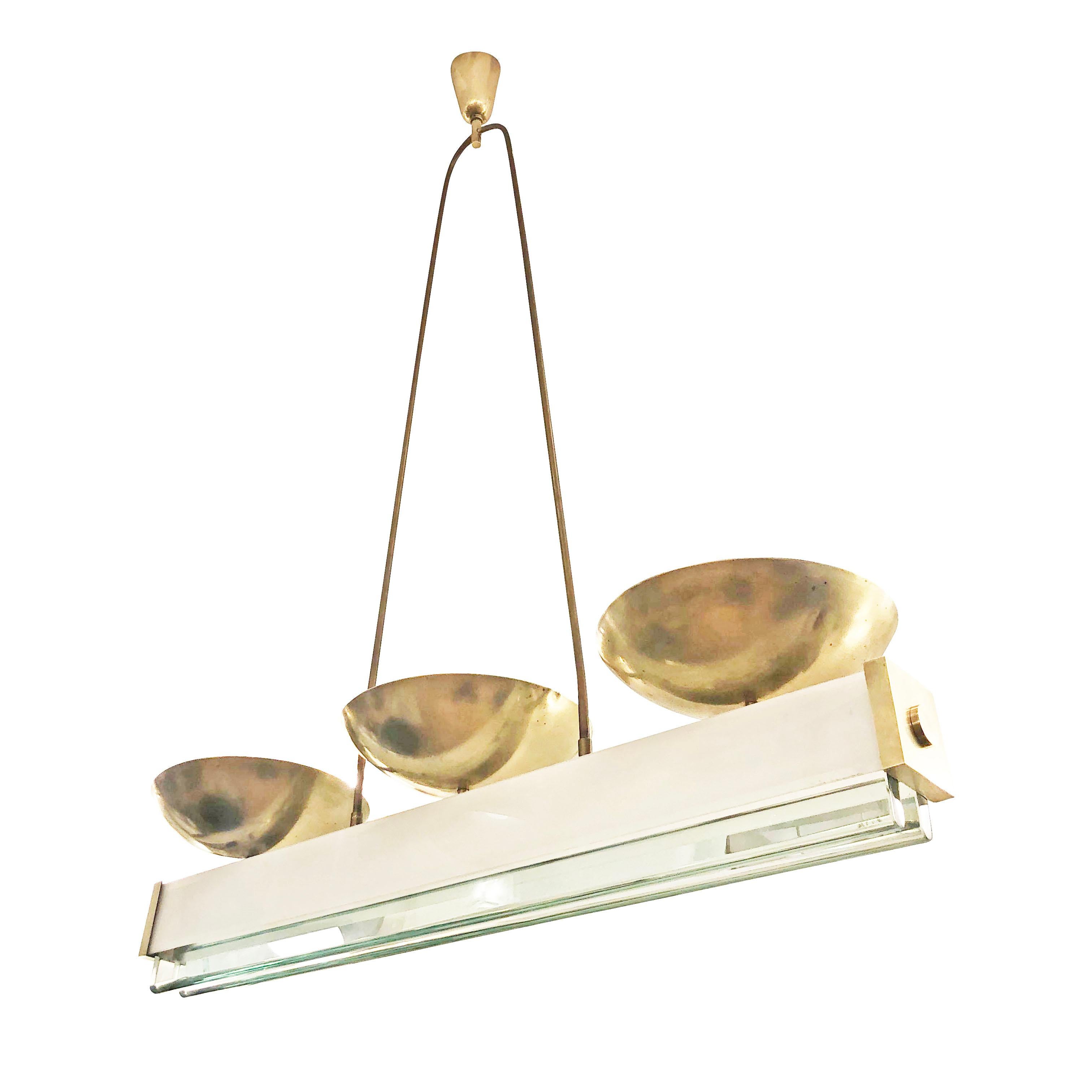 Italian midcentury chandelier attributed to Pietro Chiesa for Fontana Arte. Has three brass shades for up lighting and a rectangular body with four glasses for diffused and down lighting. The outer glasses are white and thin while the internal