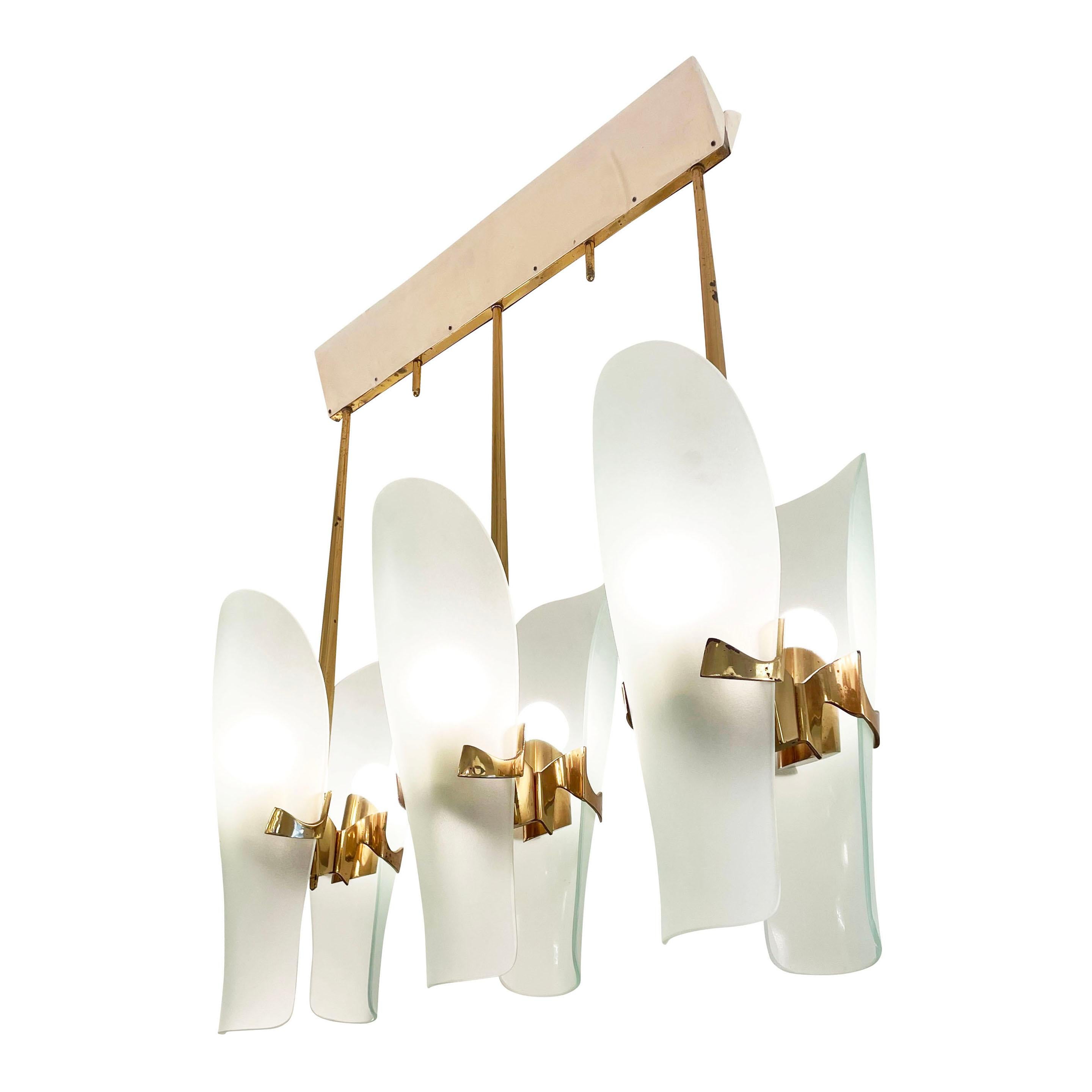 Elongated Fontana Arte chandelier designed by Max Ingrand in the 1960s. Its considered a commissioned work composed of six sconces model 1636 on a custom built frame. Each frosted glass shade mounts on a cast brass bracket and covers an E26