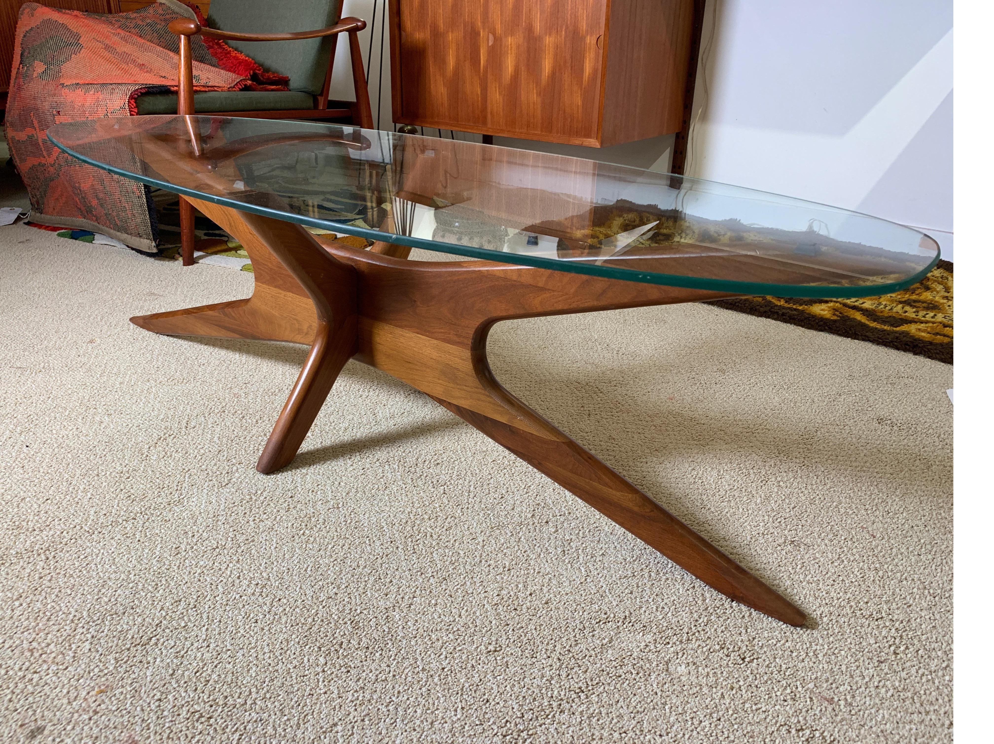 With a striking profile, this biomorphic coffee table in walnut is sure to set off any modern decor. By Adrian Pearsall for craft associates of Wilkes-Barre, PA, 1950s.