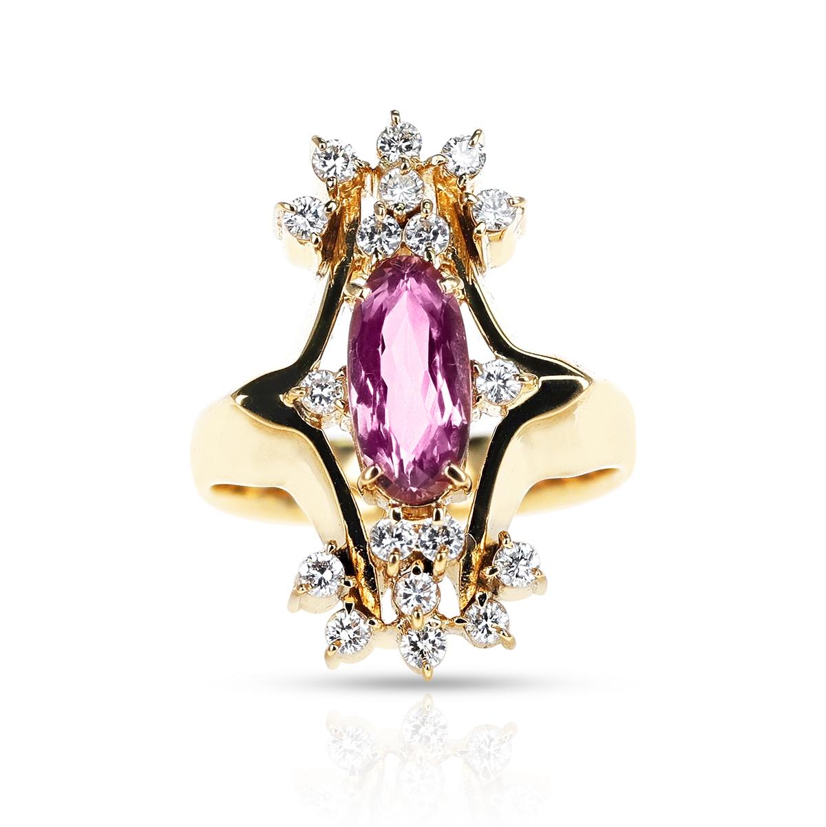 An Elongated Oval Pink Topaz and Diamond Cocktail Ring made in 18 Karat Yellow Gold.  The pink topaz weighs appx. 1.50 carats and the diamonds weigh appx. 0.45 carats. The ring size is US 7. The total weight of the ring is 12.50 grams. 