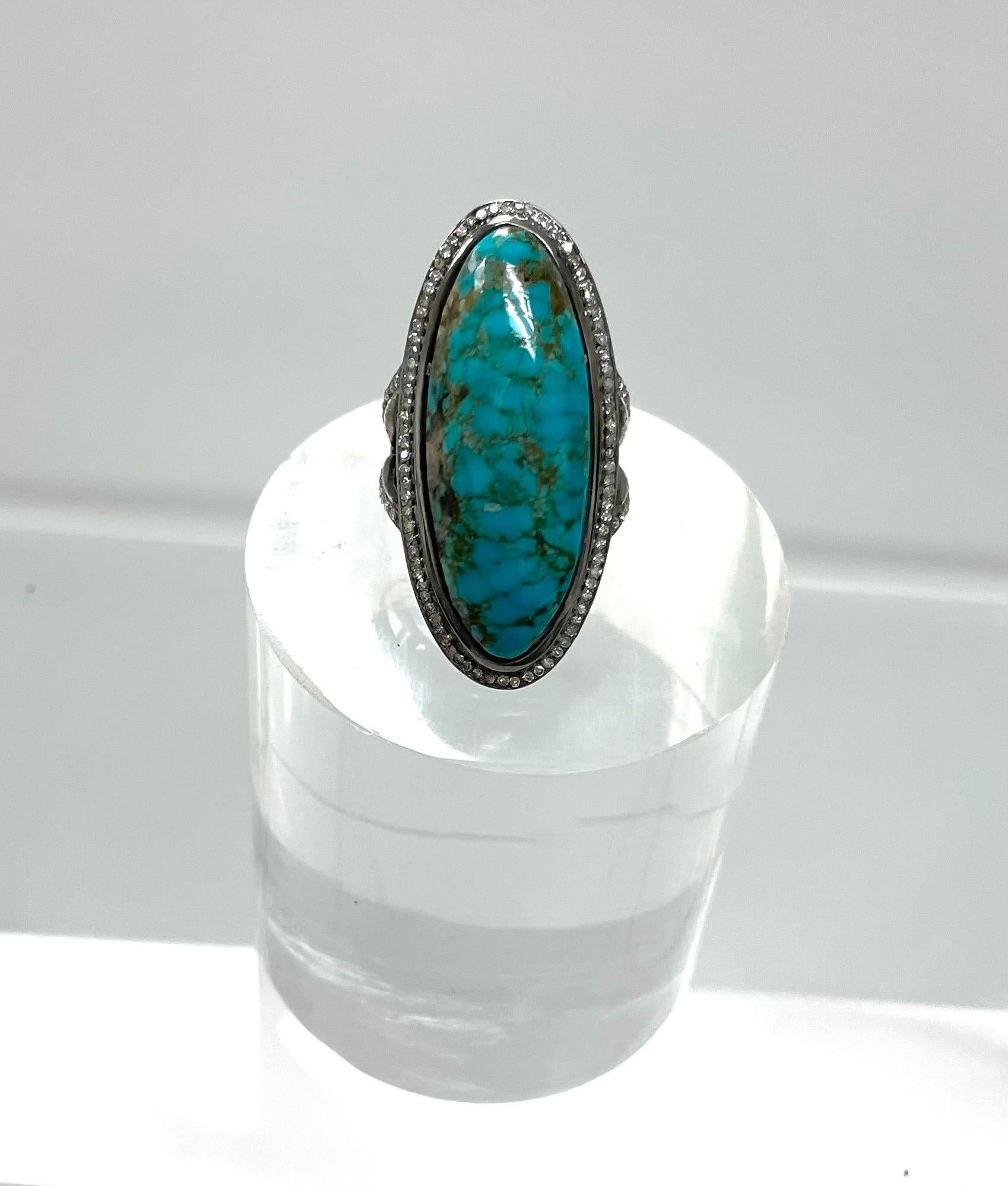 Description
Large and striking ring, featuring an Arizona turquoise high dome cabochon with beautiful matrix, framed in a pave diamond setting and a fashionable pave diamond Y-shaped band.
Item #R131

Materials and Weight
Turquoise 24cts, 36x14x7.29