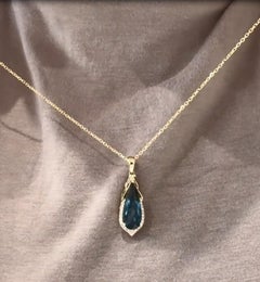 Elongated Pear Shaped Blue Topaz & Diamond Pendant Necklace in 14K Yellow Gold