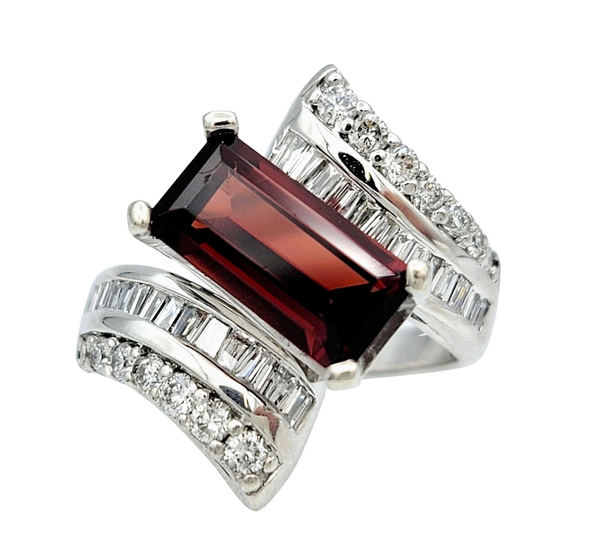 Ring size: 7.5

Indulge in the allure of sophistication with this captivating and unique band ring, meticulously crafted in lustrous 14k white gold. At its core lies a striking elongated rectangular step-cut garnet, exuding rich, deep hues that