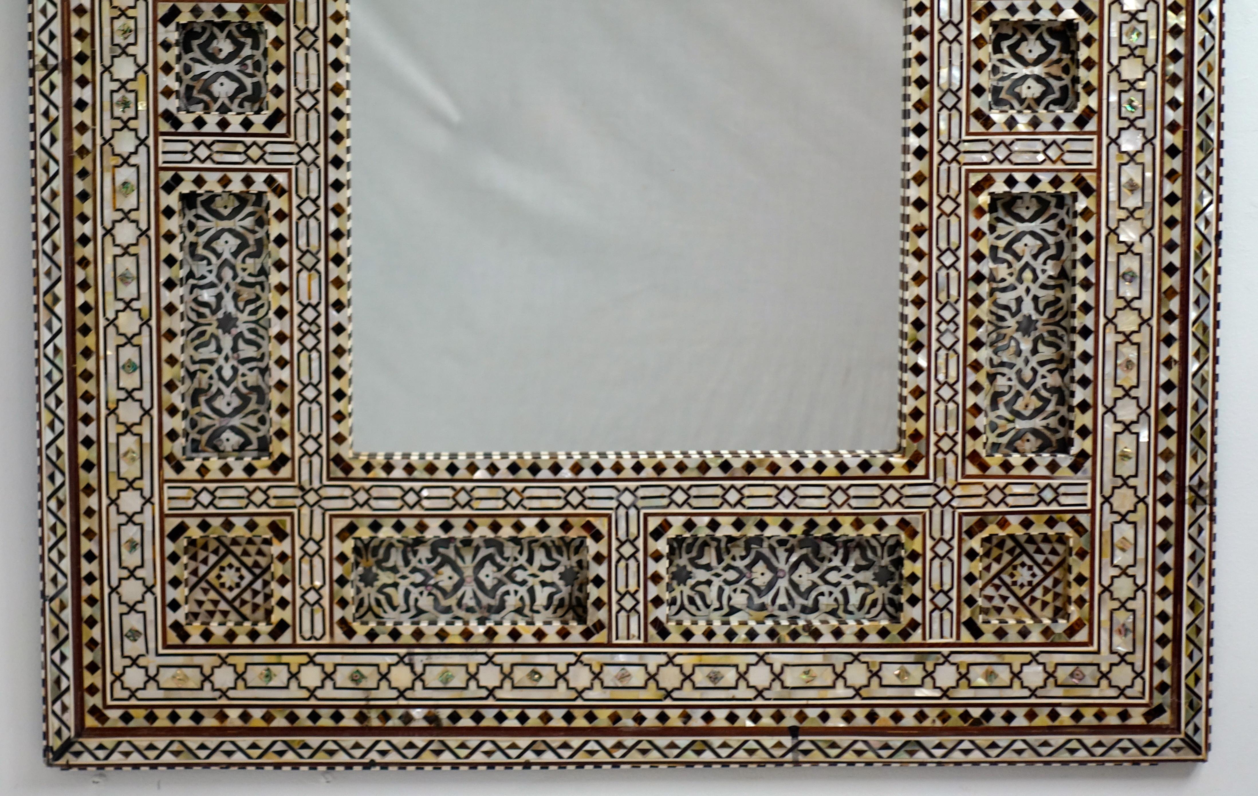 Splendid architectural and intricately decorated framed mirror from Syria.
The frame is inlaid with geometric designs of mother of peal, bone and horn.
20th century. 

