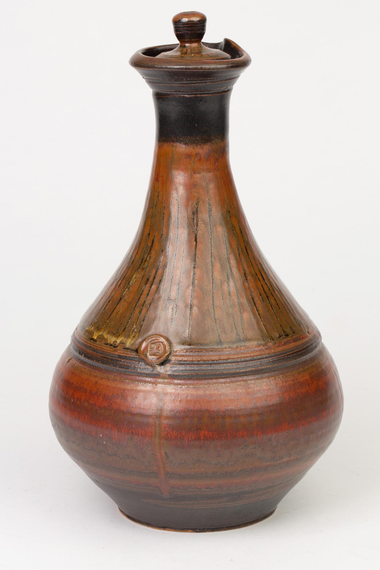 From a very large collection of 20th and 21st century Studio Pottery we offer this large and stylish Studio Pottery streak tenmoku colored glaze lidded ewer by Elsa Benattar and believed to date from the late 20th or early 21st century. This finely