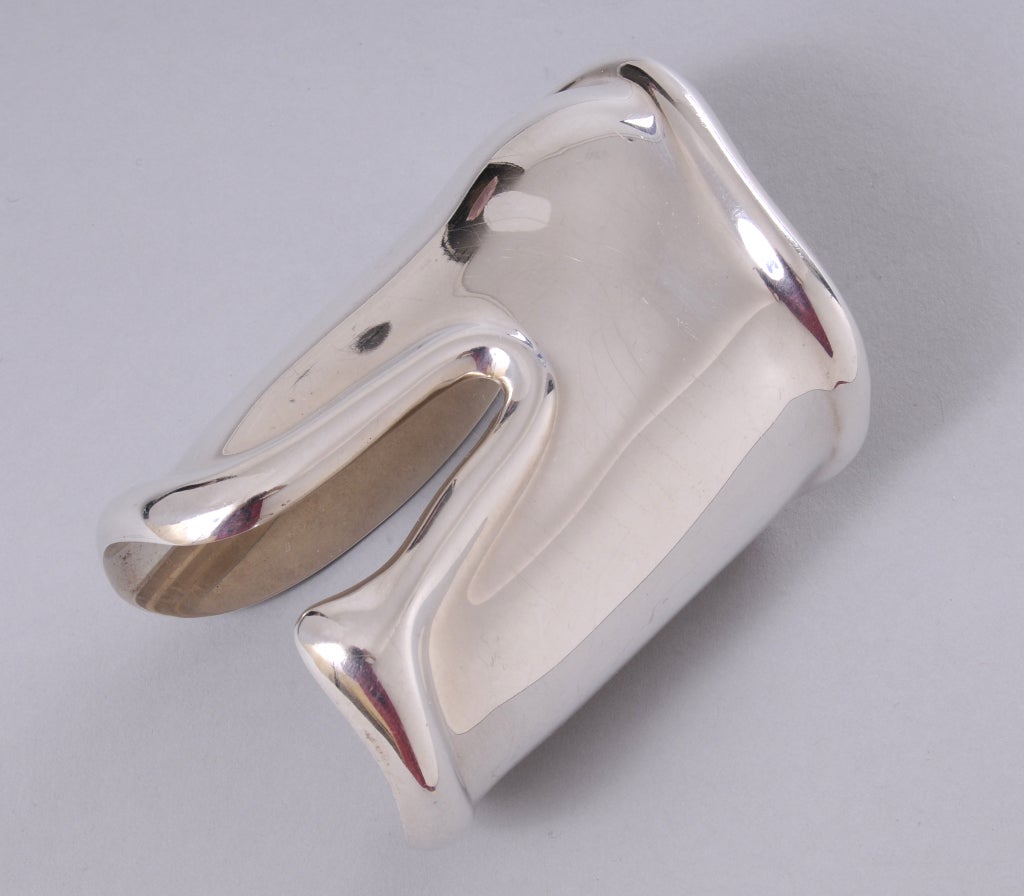 This rare small size sterling silver bone cuff was designed by Elsa Peretti for Halston in 1975 and retailed by Tiffany & Co. Made specifically for the left wrist the bump in the bracelet fits comfortably over your wrist bone. These cuffs were made