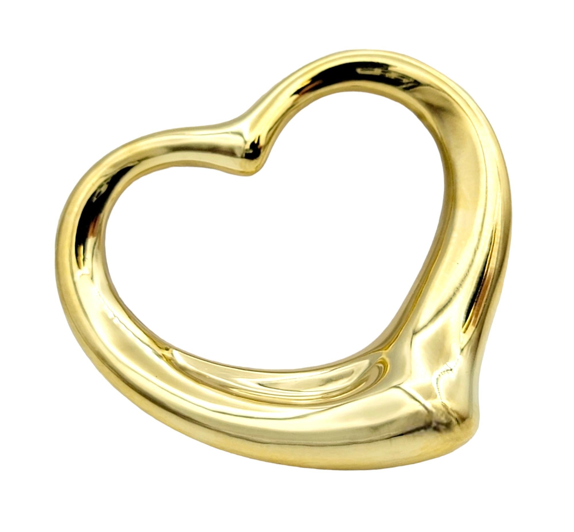Gorgeous open heart pendant necklace by Elsa Peretti for Tiffany & Co. exudes minimalist elegance. The timeless design combined with the warm yellow gold setting makes for a piece that you will admire for years to come. 

This beautiful iconic