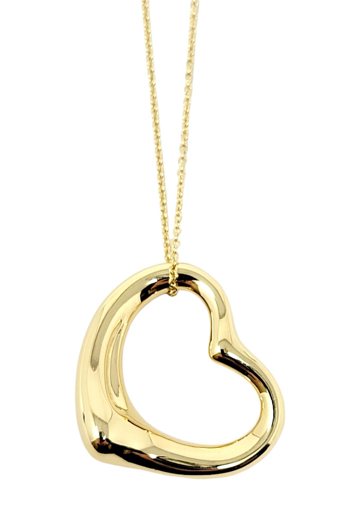 Gorgeous open heart pendant necklace by Elsa Peretti for Tiffany & Co. exudes minimalist elegance. The timeless design combined with the warm yellow gold setting makes for a piece that you will admire for years to come. 

This beautiful designer