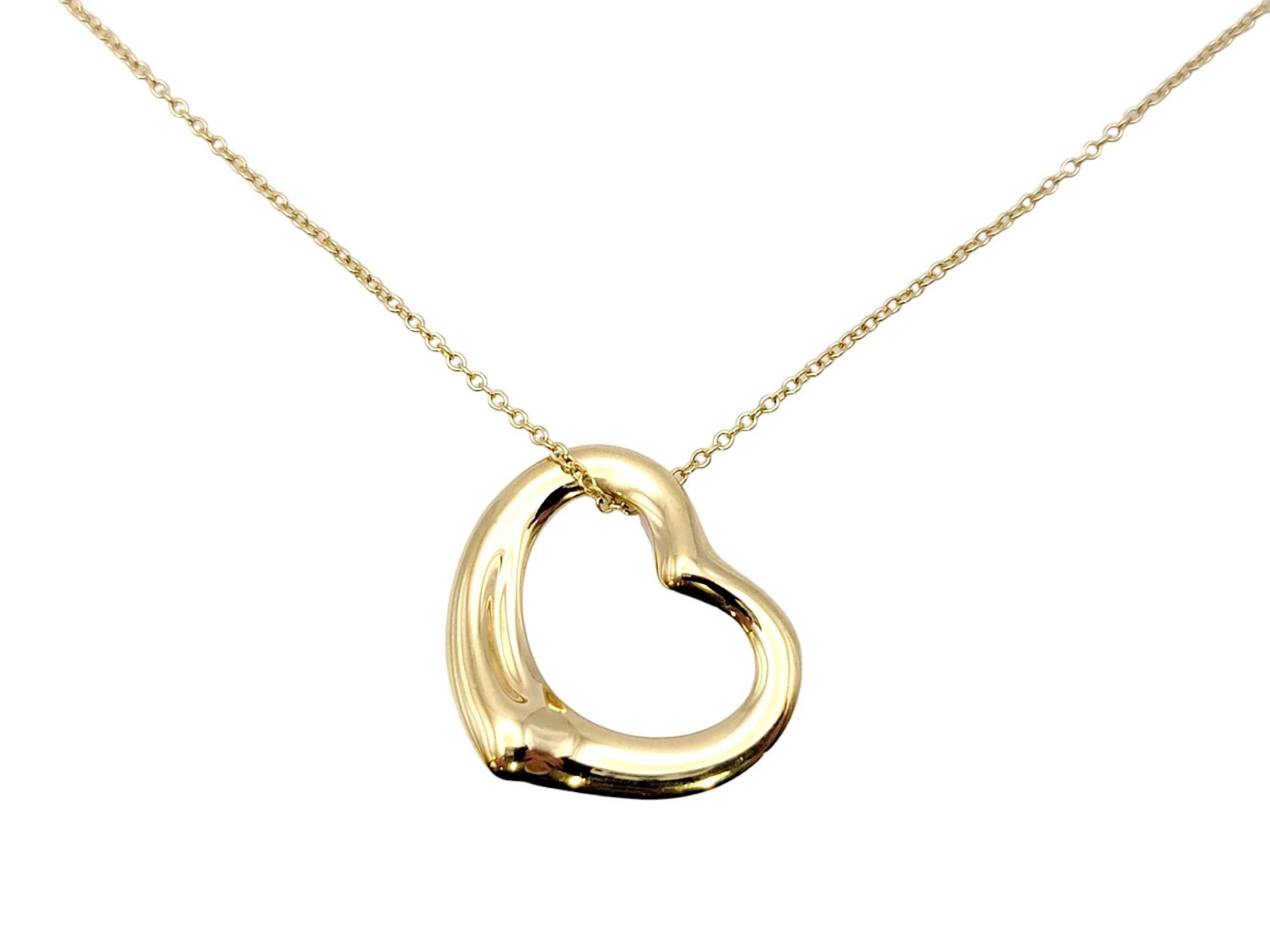 Gorgeous open heart pendant necklace by Elsa Peretti for Tiffany & Co. exudes minimalist elegance. The timeless design combined with the warm yellow gold setting makes for a piece that you will admire for years to come. 

This beautiful designer