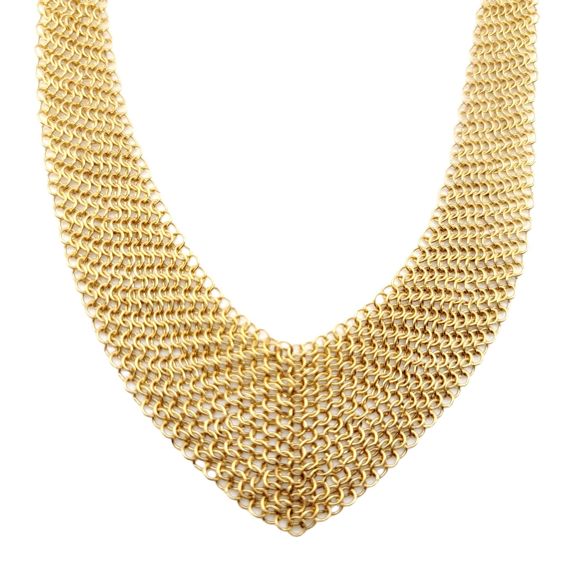 Absolutely stunning 18 karat yellow gold mesh bib necklace designed by Elsa Peretti for Tiffany & Co.. Though delicate in construction, this piece makes a bold statement. The form is malleable and ergonomic in the way it drapes over the body's