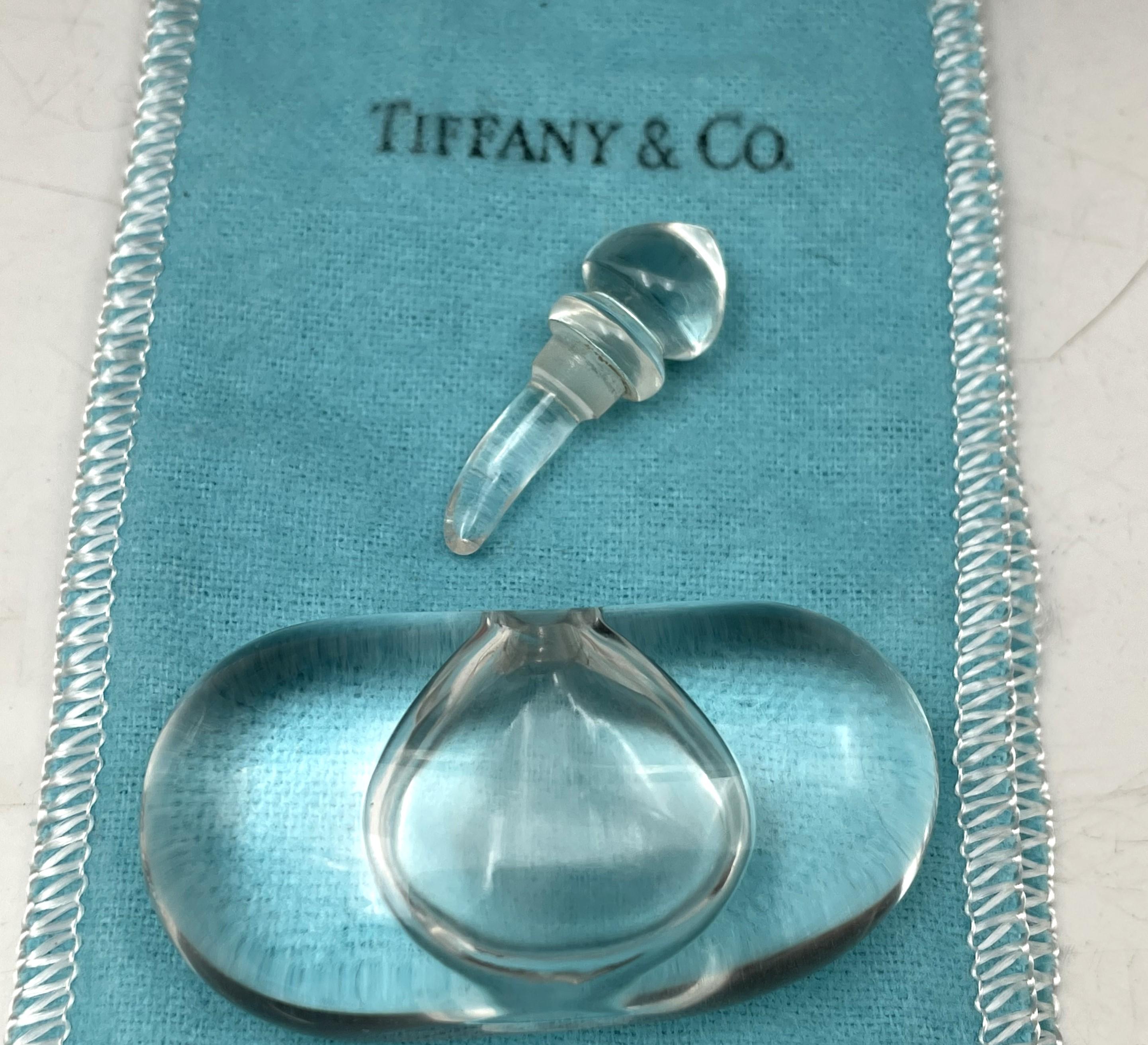Elsa Peretti for Tiffany & Co. 1981 limited edition perfume bottle made of rock crystal. This elegant bottle contains one eight of a fluid ounce, measures 1 1/3'' in height by 2 1/4'' by 2/3'' in depth, is sold with an original Tiffany blue pouch,