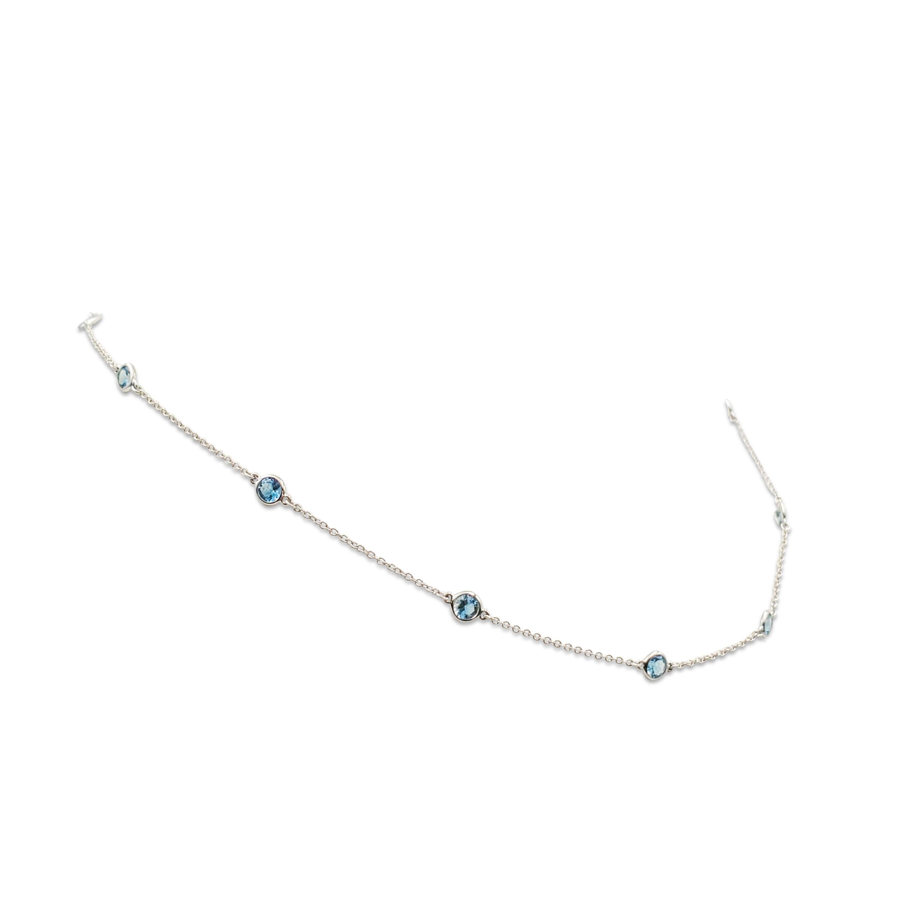 Authentic Elsa Peretti for Tiffany & Co. Color by the Yard necklace crafted in platinum.  The delicate 16 inch necklace is bezel set with 11 round cut aquamarine and measures 15 3/4 inches in length.  Signed Tiffany & Co., Peretti, PT950.  Necklace