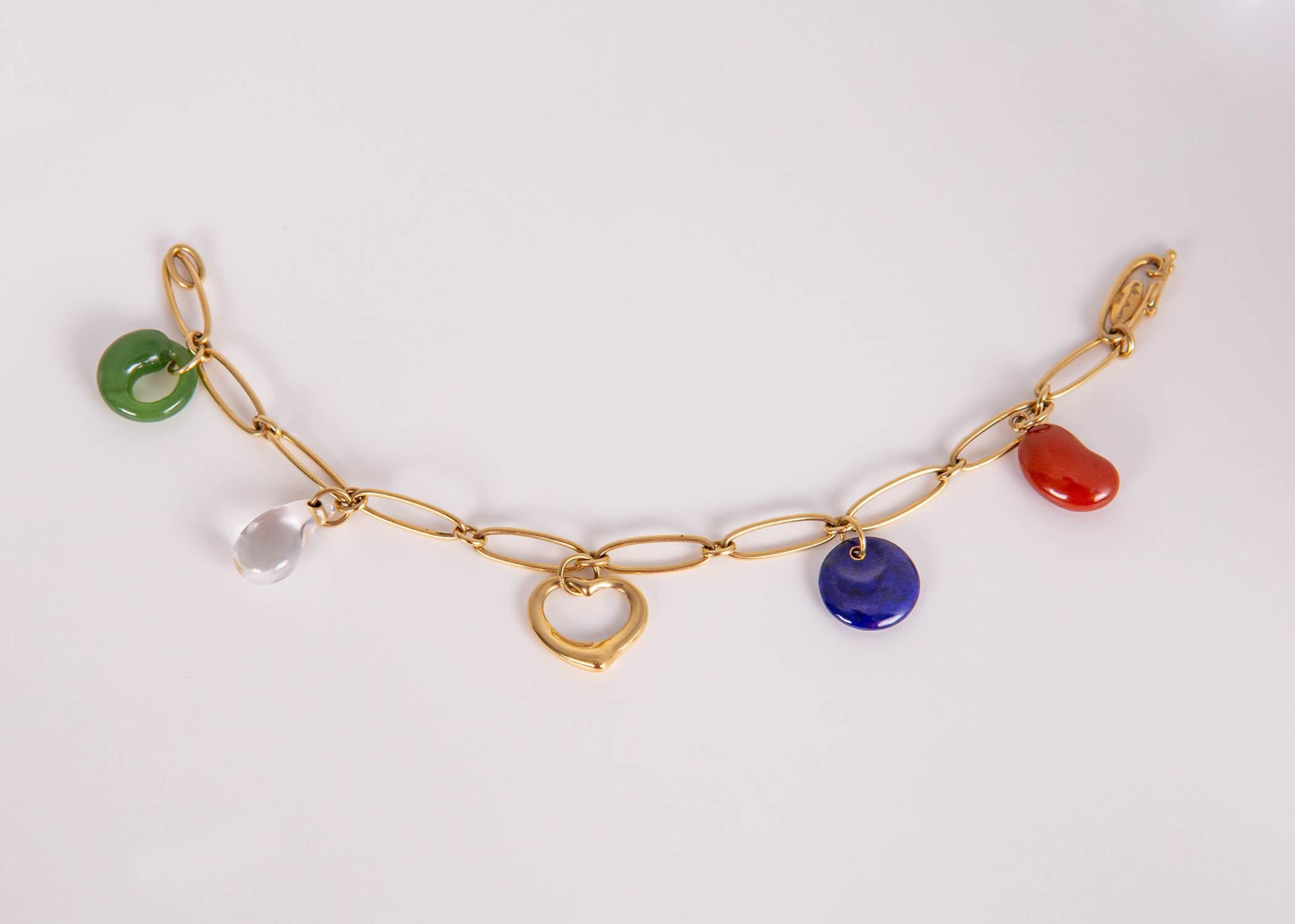 This is a collectable and rare bracelet designed by Elsa Peretti for Tiffany & Co. Jasper, lapis, rock crystal and jade are combined with rich 18k gold.  7 inches in length.