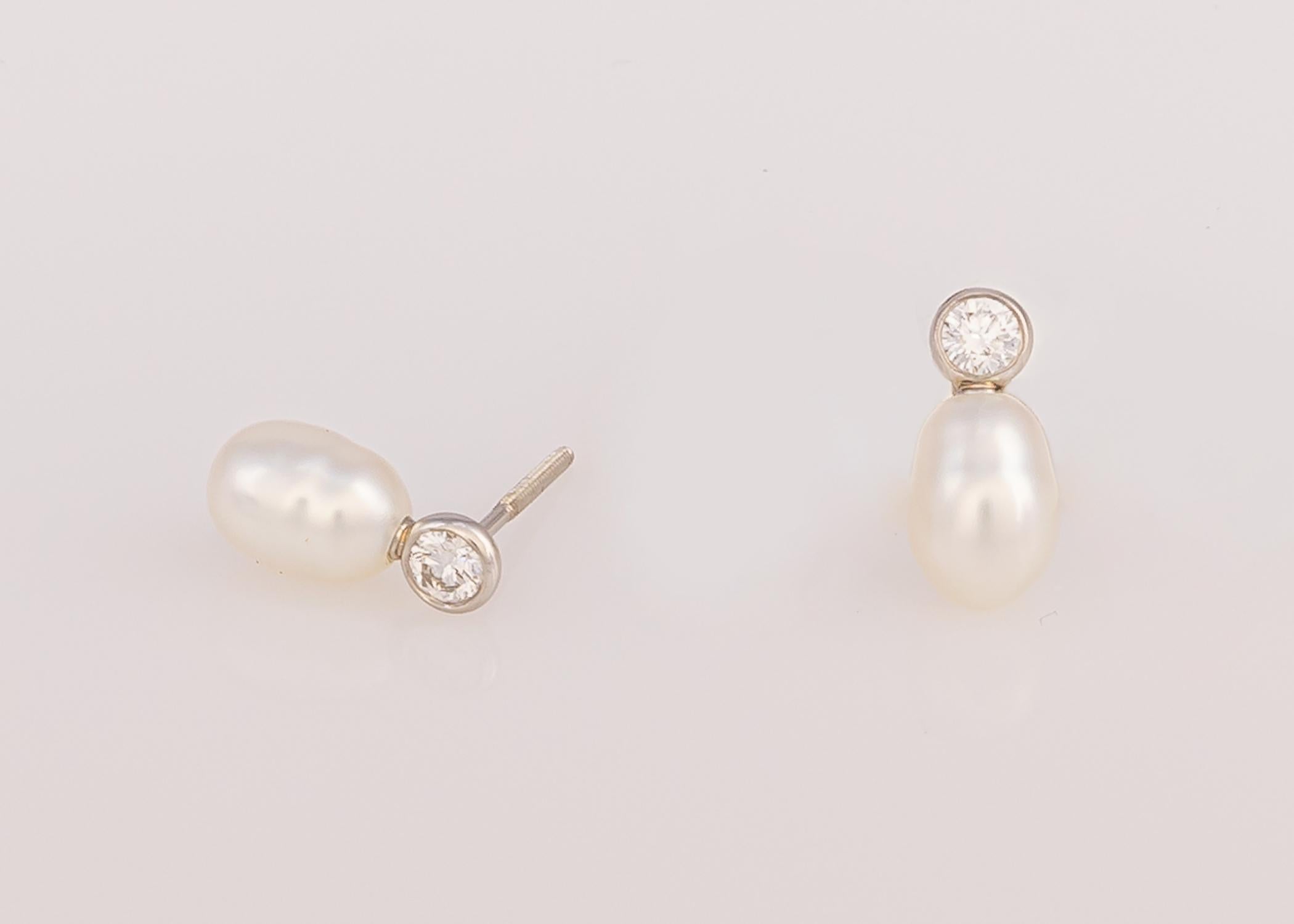 Elsa Peretti designs are iconic and collectable. This pair of earrings feature brilliant cut diamonds .30 carats total weight and a pair of white keshi pearls 9.6 x 6.6 mm in size all set in platinum with pierced screw backs. Just over 1/2 in in