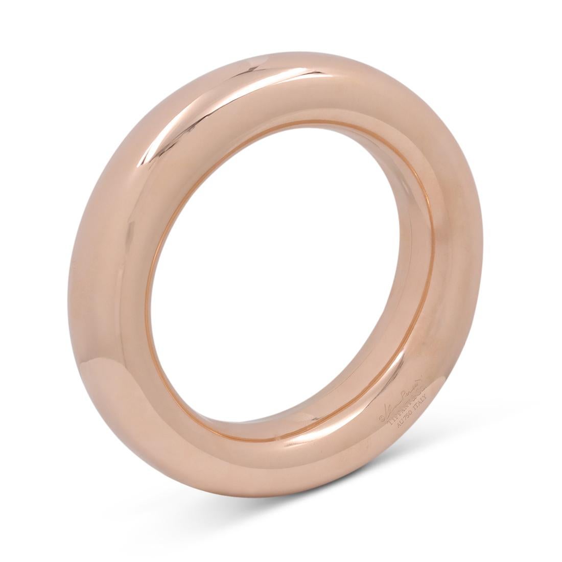 Authentic Elsa Peretti for Tiffany and Co. 'Doughnut' bangle crafted in 18 karat rose gold. Will fit up to a 6 1/4 inch wrist. The bangle is 21 mm wide. Signed Elsa Peretti, Tiffany & Co., AU 750, ITALY on the base of the bangle. The bangle is not
