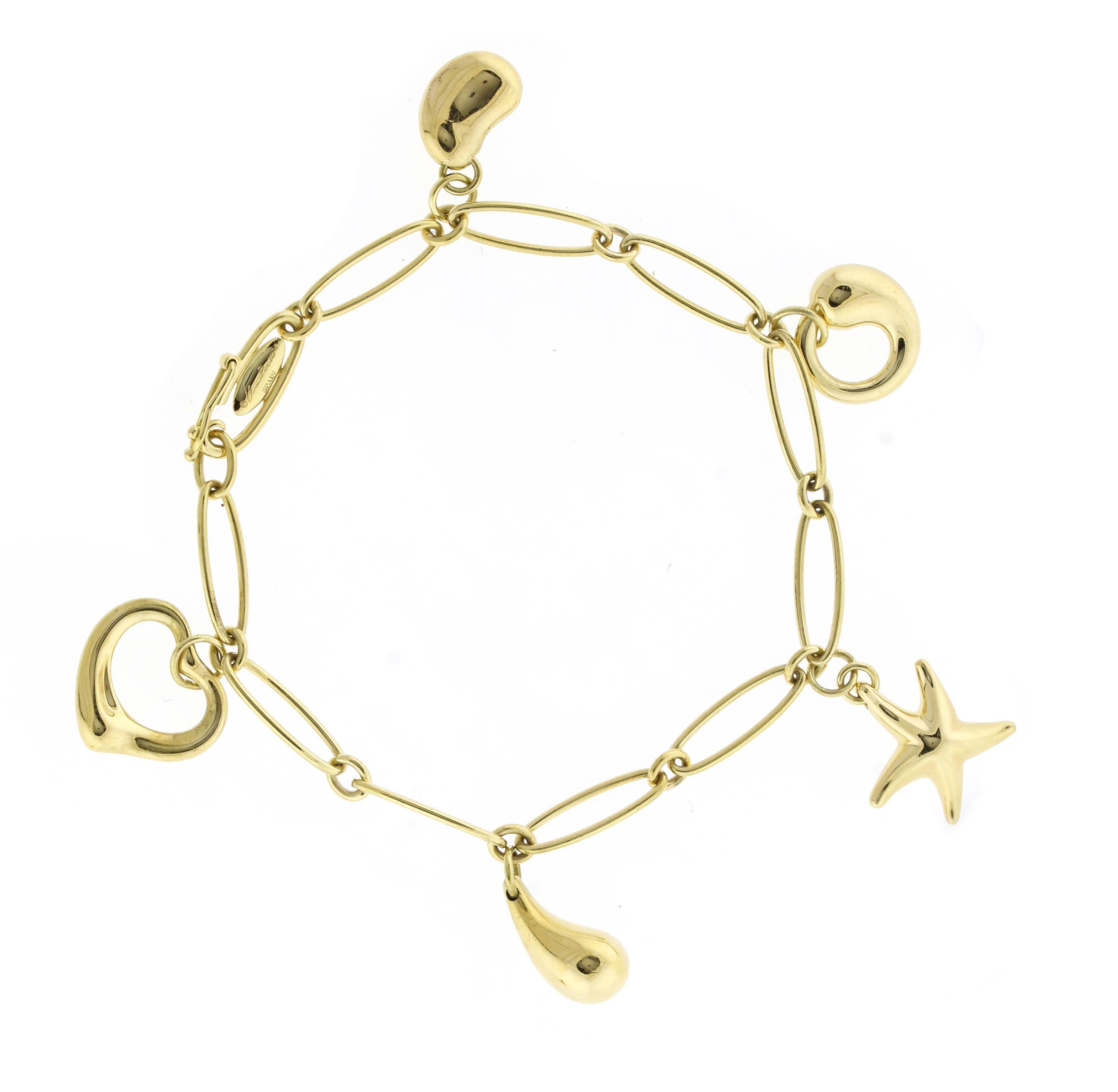 From  one of Tiffany & Co most recognized designer; Elsa Peretti, her five charm bracelet. The bracelet features her most ionic designs: loving heart, infinity, teardrop, bean and star fish.   18 karat gold , seven inches long 