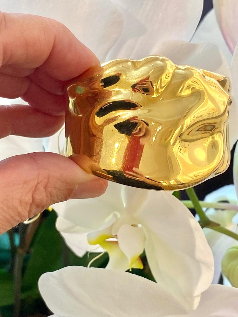 An 18 karat gold Capricorn zodiac cuff, by Elsa Peretti for Tiffany & Co., Spain, 1982. Stamped Peretti  Tiffany 18K © 1982 Spain. 
Inner circumference of cuff 6.37