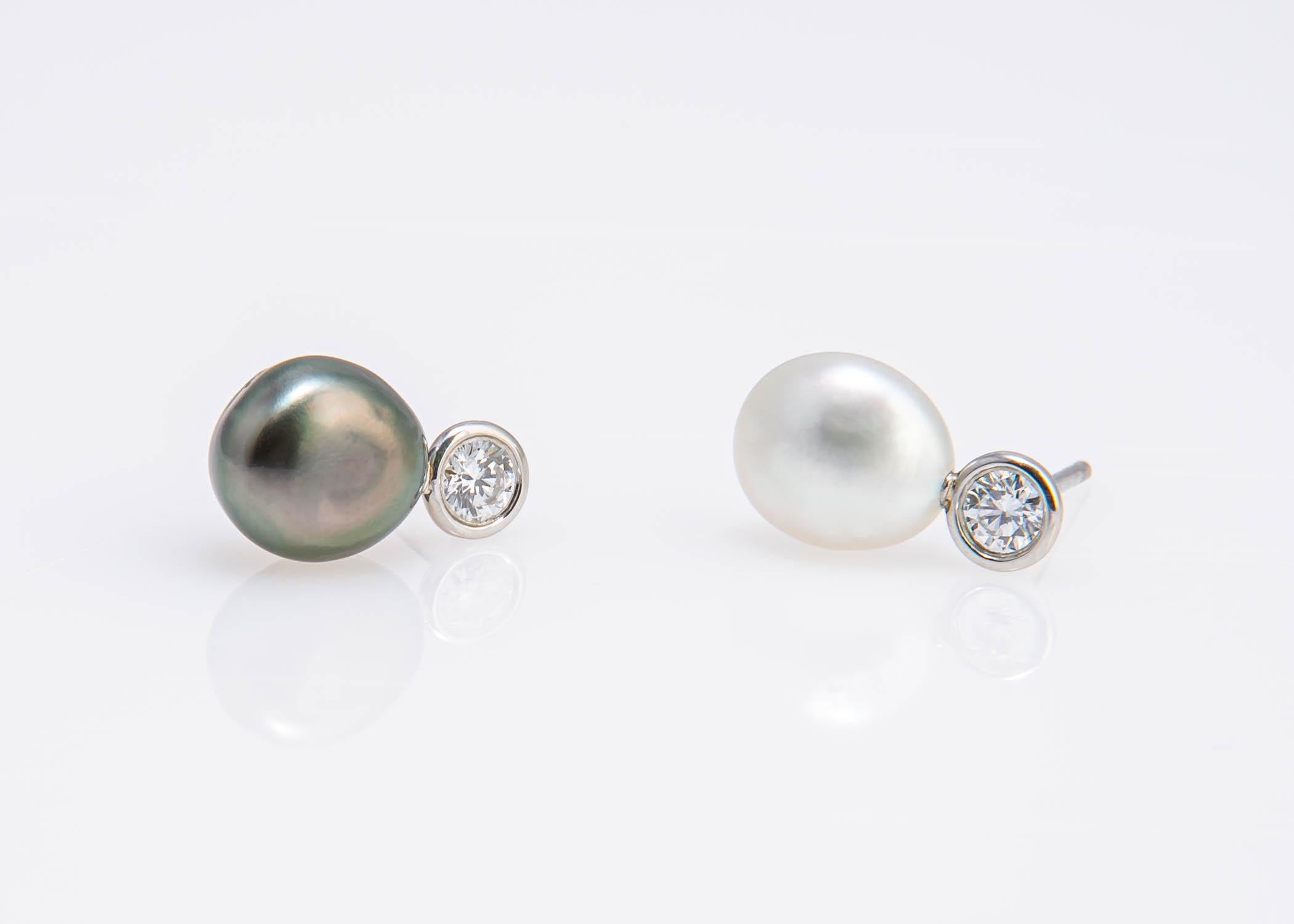 Simple and pure. Elsa Peretti pairs one black and one white Keshi pearl with two brilliant cut diamonds set in platinum to create this unique chic collectable pair of easy to wear earrings. Your new signature piece. The two diamonds total .28 carats