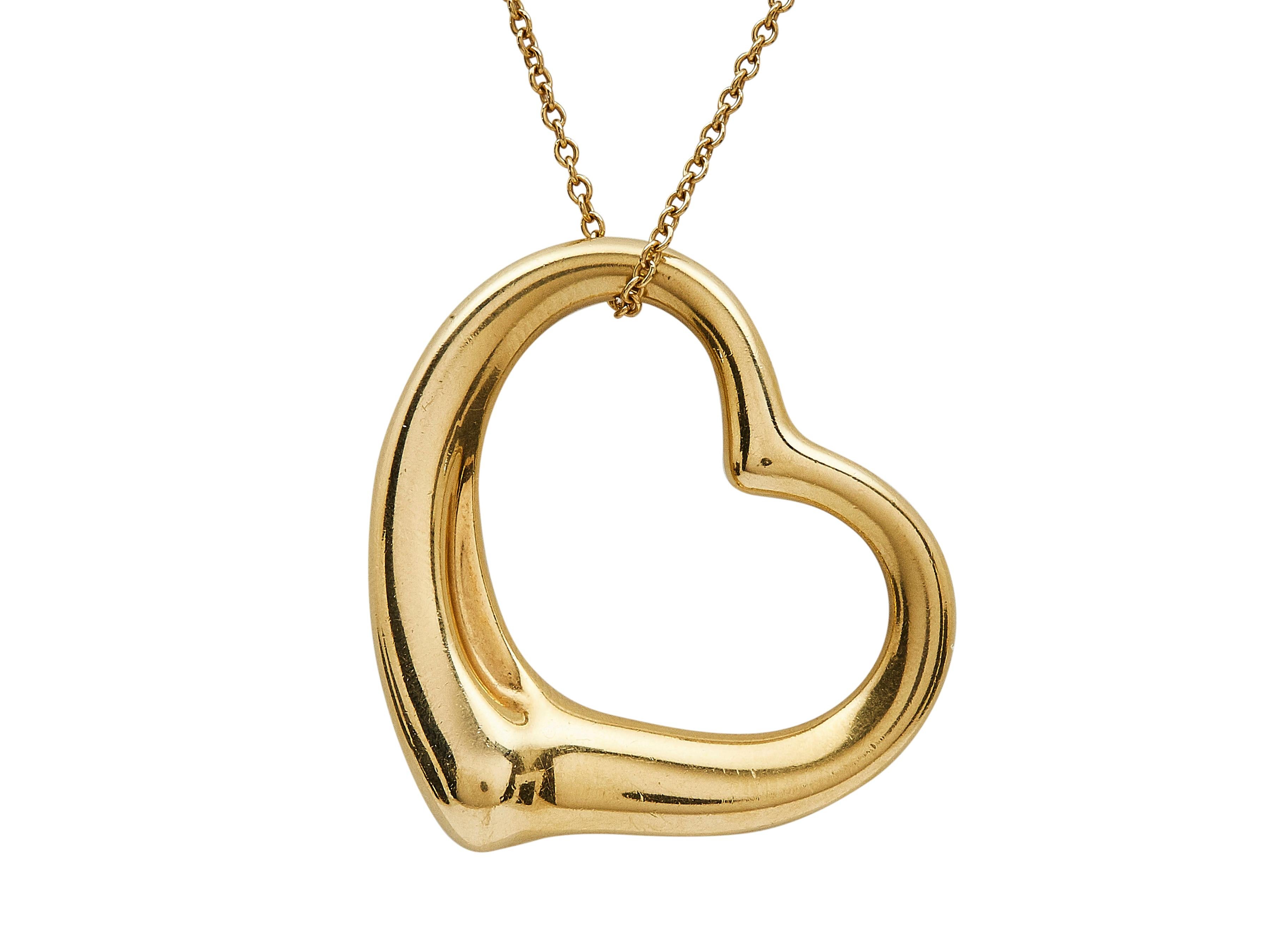 The necklace:
A Elsa Peretti for Tiffany & Co. Open Heart eighteen karat yellow gold pendant necklace.

The necklace is in very good condition, with moderate surface wear and minor scratching. 

Accompanied by it's original box.

More on the